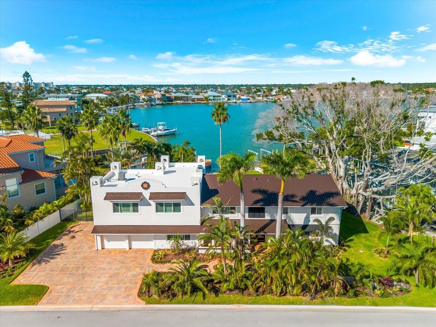 INCREDIBLE SAVINGS AND OWNER FINANCING AVAILABLE - make this waterfront showstopper a part of your portfolio today!

If you’ve been waiting for a waterfront home that can truly handle hosting, holidays, and multigenerational living… this is it.

With sweeping views of Boca Ciega Bay, an open-concept layout, and a chef’s kitchen featuring dual islands + dual dishwashers + wine fridge + double ovens, this home is built for connection and celebration. Every bedroom has its own en-suite bath, and the primary suite feels like a private retreat with a terrace overlooking the water—perfect for sunrise coffee.

Movie nights? Covered. A second living space off the primary suite becomes your own theatre room with a wood-burning fireplace. Outside, the fun continues with a resort-size pool, pergola, fire pit, nearly 0.4 acres of lush yard, and even a dedicated indoor dog bath.

Boaters will love the private dock + 10,000-lb boat lift, and you’re just across Gulf Blvd to white sands and Gulf beaches.
New impact windows (2024) + new metal roof (2024) add major peace of mind, along with an elevator and thoughtful upgrades throughout.

This is a rare chance to secure a luxury waterfront lifestyle with options.