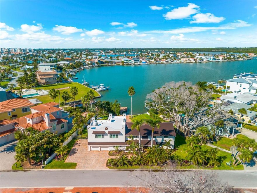 A waterfront escape designed for hosting large gatherings and multigenerational living! As you arrive at the property, you’ll immediately notice the expansive parking area for up to eight vehicles, perfect for all your guests. Step through the double doors to be greeted by wide-open views of Boca Ciega Bay and open-concept living at its finest.

The chef’s kitchen features dual islands, dual dishwashers, a wine fridge, and versatile double ovens, seamlessly flowing into the sunny living and dining areas. Five spacious bedrooms each complete with an en-suite bathroom, including a flexible office option offer comfort and privacy for all. The primary suite, with its own private terrace, provides a perfect retreat to enjoy your morning coffee. Just off the primary suite, a second living room transforms into a movie theatre with a wood-burning fireplace ideal for cozy nights in. 

Step outside to embrace poolside festivities beside the resort-size pool and pergola, and end evenings gathered around the firepit. Enjoy nearly 0.4 acres of lush grounds, plenty of grass for your furry friend to play, and a dedicated indoor dog bath when it’s time to clean up. A private dock with a 10,000-lb boat lift brings Boca Ciega Bay to your doorstep, and quick beach access places the Gulf’s sugar sands just moments away. An elevator, two water heaters, three thermostats, plantation shutters, new impact windows (2024), and a new durable metal roof (2024) add convenience and peace of mind.

Whether hosting family gatherings, corporate retreats, or enjoying multigenerational living, there’s room for everyone to relax and find their own private space. Every detail is woven seamlessly for magical moments, countless memories, and a coastal waterfront lifestyle where excitement and serenity meet. Seller is open to some seller financing. Back on market after buyer default. Escrow was never deposited and no inspections took place, cancellation was unrelated to the condition of the home.