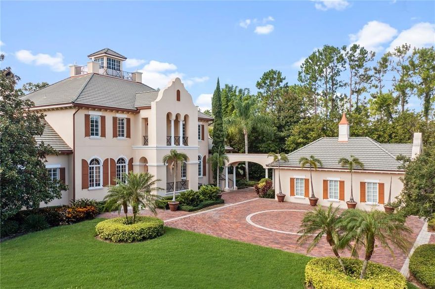 One or more photo(s) has been virtually staged. Formerly featured on the Street of Dreams, this stunning home will make you feel like you’re at a luxury resort in Bermuda. Designed by Mark Nasralla and built by Ray Coudriet, this one-of-a-kind residence is perfectly positioned on over one acre in the 24-hour guard-gated community of Lake Butler Sound. The main house features five oversized bedrooms and five-and-a-half baths, and then there is a detached guesthouse with a guest suite and fitness center. As you step through the front doors, your eyes are immediately greeted by soaring two-story ceilings and bright, airy open spaces. The chef’s kitchen features beautiful custom cabinetry, two islands, each with its own sink, lovely granite countertops, two dishwashers and a huge hidden pantry. The master suite features a separate sitting area overlooking the huge yard and pool, along with a gas fireplace. The spa bath is sure to be a favorite with its massive walk-in closet and an oversized soaking tub with a fireplace for a relaxing evening at home. There is also a great room with a two-story wall of windows, large family room off the kitchen, formal dining room, a sunroom with vaulted ceilings and custom wood beams, a home office and an amazing game room on the second floor. Exterior amenities include a spectacular second-floor balcony overlooking the backyard, with a massive swimming pool, hot tub and a cabana with a bar, sauna and separate pool bath. This amazing residence is located just minutes from fine dining, world-class shopping and all of the area theme parks; the location of this spectacular home simply can’t be beaten.