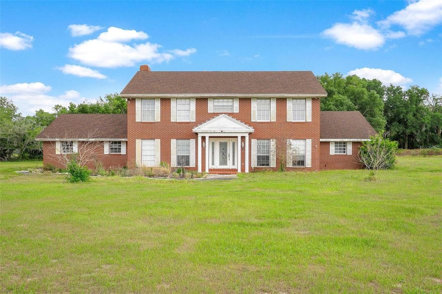 PRICED BELOW 2026 APPRAISAL! Nestled in an incredible location just minutes from all the shopping, dining, entertainment, and conveniences of The Villages, this rare property offers endless possibilities for those looking to create their dream homestead, investment opportunity, or private country retreat! Situated on almost 8 acres with plenty of room to roam, this five-bedroom home is bursting with potential and waiting for the right owner to bring it back to life. From the moment you arrive, you’ll appreciate the peaceful setting, open space, and the feeling of privacy while still being close to everything. Properties with this much land in such a prime location are becoming harder and harder to find! Whether you envision gardening, bringing animals, adding workshops or garages, or simply enjoying wide open spaces, this property gives you the flexibility to make it your own. The home offers a fantastic layout and solid bones with ample living space for a large family, multigenerational living, or even a future income-producing opportunity. With a little love, vision, and updating, this home could truly shine and become something special. The possibilities are endless! Opportunities like this don’t come around often! If you’ve been searching for acreage, location, and unlimited potential, this could be the perfect property for you. Bring your imagination and transform this hidden gem into the showplace it was meant to be!