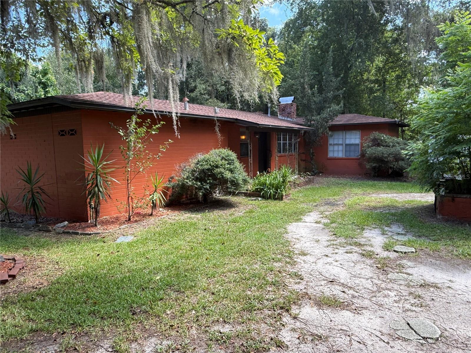 Brick 3 bedroom/2 bathroom home in SW Gainesville on a .75 acre lot. Less than 2 miles from downtown Gainesville and 5 minutes from Shands, UF and the VA. This home sits on a corner lot with plenty of yard space, featuring wood floors, cabinets and granite countertops. Roof is 5 years old and water heater is less than 2 years old. Two tenants paying $1360 in rent who are month to month, with one room left to rent if you choose this as an investment property, or could turn it into an Airbnb with its prime location.