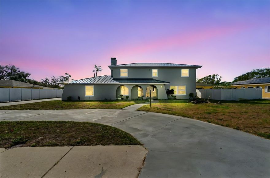 Welcome to this beautifully updated two-story home in Pinehurst Estates, a well-established riverfront community along the south side of the Manatee River. Situated on a spacious .36-acre oversized lot, this residence offers a rare combination of space, functionality, and flexibility.

Inside, the home features updated flooring and fixtures throughout, with formal living and dining areas ideal for entertaining. The heart of the home is the expansive great room with a wood-burning fireplace, seamlessly connected to the kitchen and designed for everyday living and gathering. The kitchen offers white cabinetry, granite countertops, stainless steel appliances, and ample workspace.

French doors lead to a large screened outdoor area, complete with a built-in bar and generous room for relaxing or hosting guests. The property provides exceptional parking and storage options, including a three-car attached garage with an additional bath, plus a detached drive-through garage/workshop with roll-up doors on both ends—ideal for hobbies, additional vehicles, or future conversion possibilities.
All bedrooms are located on the second level and include four generously sized rooms, along with three full baths and an additional half bath. The oversized lot allows for endless outdoor potential, including room for a pool, garden, or expanded outdoor living space.
Additional highlights include a durable metal roof, circular drive, boat parking, no HOA, flood zone X, and a prime location close to river access, shopping, dining, and major roadways. The home is vacant, move-in ready, and available for quick closing.
