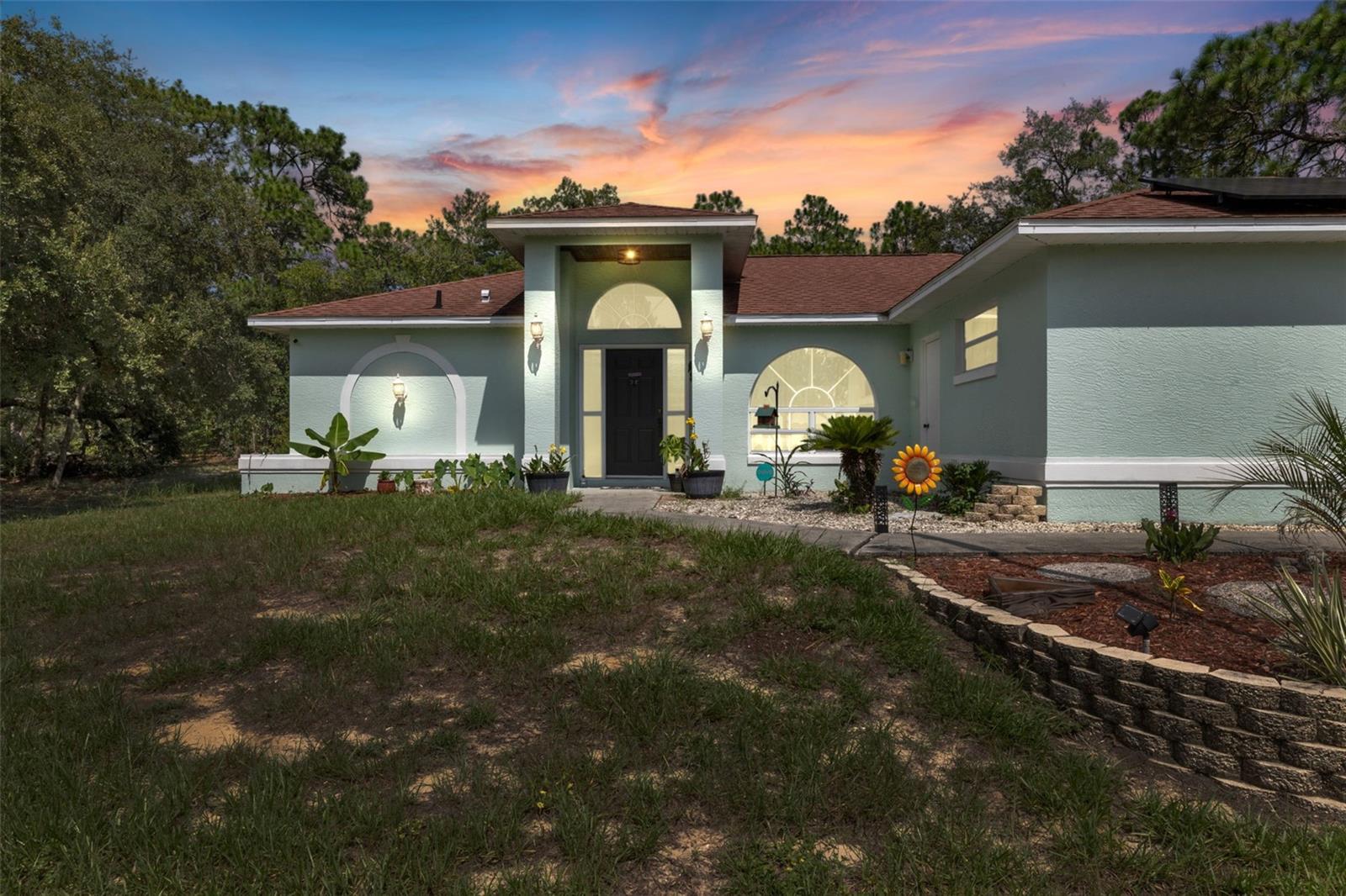 Discover timeless comfort and energy-efficient living at 2931 W Beamwood Drive in the heart of Pine Ridge Estates. a beautifully maintained custom-built residence located in the sought-after equestrian community. Sitting on a scenic 1.06-acre corner lot, this thoughtfully designed 3-bedroom, 2-bathroom home with an attached 2-car garage offers privacy, functionality, and a peaceful country lifestyle. Mature trees, lush landscaping, and a long private driveway create a serene setting with plenty of space to spread out, entertain, or simply enjoy the quiet surroundings. Inside, you'll find a spacious and open layout featuring vaulted ceilings, skylights, a formal dining room, and a large great room—perfect for both everyday living and entertaining. The custom kitchen boasts solid wood cabinetry with butcher block countertops, a large farmhouse sink, new stainless-steel appliances, a walk-in pantry, and a bright breakfast nook that overlooks the backyard. Luxury vinyl plank flooring throughout the living areas, while all three bedrooms are finished with plush carpet for added comfort.
The split-bedroom design ensures privacy, and the primary suite features a walk-in closet, dual sinks, and a tiled walk-in shower. Sliding glass doors from the primary suite lead out to an expansive screened lanai—a perfect space to enjoy Florida’s outdoor lifestyle in comfort and shade. This home is equipped with a 2023 solar panel system, significantly reducing your energy costs. The current electric bill averages just $35/month giving the new owner long-term energy savings. Other key updates include a new water heater (2023), roof replacement (2017), and HVAC system (2013). A detached workshop/utility building offers versatile space for storage, hobbies, or equipment. Located in the highly desirable Pine Ridge Estates, this home comes with access to one of Citrus County’s premier equestrian facilities. The community features over 28 miles of deeded horseback riding and walking trails, a full-service equestrian center with 13 tree-shaded pastures, auto-waterers, flexible horse-safe fencing, a large main riding arena, jump ring, dressage arena, obstacle arena, and round pen. Residents enjoy a low annual HOA fee of just $95/year, making this an exceptional value for the amenities and lifestyle offered. Situated just minutes from shopping, dining, golf, and the Crystal River coastline this home offers a rare opportunity to enjoy energy-efficient living, modern upgrades, and a true connection to nature—all within a vibrant equestrian community. This is more than just a home it's a lifestyle.
Schedule your private showing today!