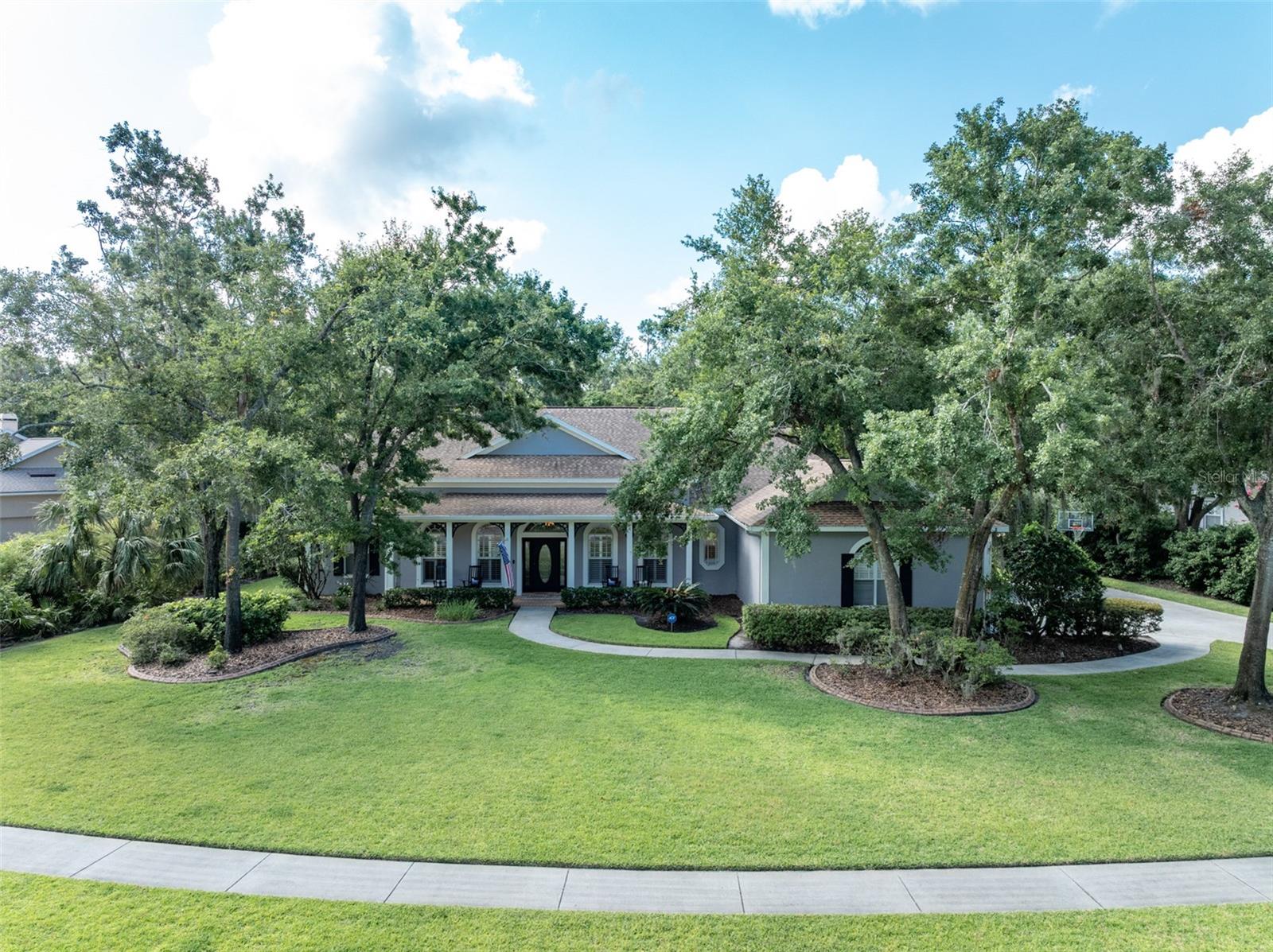 NEW PRICE!! Sellers are MOTIVATED to sell quickly!! This charming home is located in the highly sought after gate guarded (24/7) community of Fish Hawk Trails with large executive homesites, miles of trails, wide streets, tennis, basketball, pickleball courts & community center, all surrounded by nature & zoned for some of the best schools in the county. Sitting gracefully on a private .63 acre conservation lot with an inviting covered front porch. You will be smitten the moment you arrive!! Step inside onto distressed wood look tile flooring that continues throughout the home with laminate in all bedrooms. The formal dining area & office are located on each side of the foyer with views to the breathtaking outdoor living space straight ahead. The office features chic built ins with shelving above & barn door. The expansive great room features double coffered ceilings with crown molding & inset lighting along with a wood burning fireplace, overlooking the outdoor living space through triple sliders with imbedded panes that pocket all the way open expanding your living space. You will fall in love with the beautifully updated kitchen with gorgeous stone tops, GE Cafe double ovens & refrigerator, Viking Professional Island Cooktop, dishwasher, farm sink, microwave, wine chiller & soft close cabinetry & drawers. There is plenty of seating around the counter in the kitchen making it perfect when entertaining guests & large gaterings. The dinette area in the kitchen overlooks the pool area. The primary suite is privately located on one side of the home & features laminate flooring, sliding door access to outdoor space, plantation shutters, two walk in closets & an EnSuite Bath with walk in shower, soaking tub & dual vanities. The secondary bedrooms are spacious & are located on the opposite side of the home with one bedroom off by itself with an adjacent updated bath. The other two bedrooms share an updated bath & can be closed off for additional privacy. You will love spending your free time in your very own tropical paradise in the outdoor living area which features a sparkling saltwater pool with stone waterfall, tropical landscaping & stone decking with a covered seating area. In the evening, the LED lighting embedded in the aluminum framing of the lanai is impressive & creates the perfect ambience for relaxing in the hot tub. The backyard is very spacious & backs to wooded conservation giving you the utmost in privacy. Spend chilly evenings conversing with family & friends while sipping your favorite beverage & roasting S'mores. This home has something for everyone, even your beloved pets will have a fenced in area on one side of the yard. Additional features include: freshly painted exterior (2023), ring doorbell & two exterior cameras, high baseboards, coffered ceilings in office, dining area, great room & primary suite all trimmed with crown molding, plantation shutters & shades, newer lighting fixtures, new HVAC (2024), new water heater (2024), Roof (2018), well for irrigation providing significant savings on water bill & a spacious 3 car side entry garage. There is so much to love about this wonderful home!! Make your appointment to see it today!!