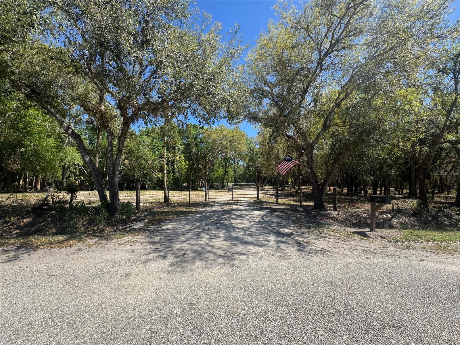 WOW HUGE PRICE DROP! Start submitting your offers if you are looking for the perfect hidden home sight or weekend getaway spot because you have found it! This 5-acre blank slate with electric, well and septic is just sitting here waiting for your personal touch. The current owner has put in the work to clear and grate some of the land and has installed a 200-amp service to support a homestead as well as an RV hook up so you can live on site while you build! This lot is surrounded by shady oak trees, stunning cypress trees, the occasional bamboo, and various other trees and plants that create a diverse and vibrant ecosystem. This property also comes with a powered storage building that the owner used to store tools, camp gear and a refrigerator for food on their weekends away from the city life. WAIT THERE'S MORE, the fenced and gated property also comes with a water softener system for the well and is zoned residential mixed use which allows housing for manufactured, mobile or single-family homes as well as agricultural buildings and grazing livestock! Don't let this piece of Florida paradise pass you by!