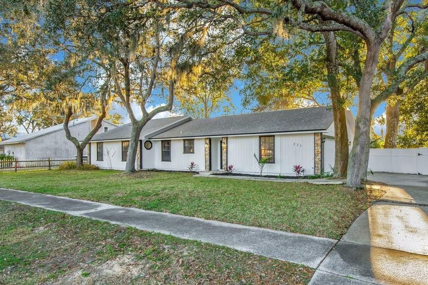 Don’t miss this rare opportunity to own a beautifully remodeled home in Sweetwater Hills of Port Orange. Every detail is meticulous. Upon arrival you can't help but notice the curb appeal with fresh exterior paint and a long driveway framed by new landscaping to the elegant solid fiberglass front door. Inside, the brand-new gourmet kitchen shines with stylish cabinets, a large breakfast island with a waterfall edge countertop, stainless steel oven, Bosch dishwasher, stainless steel refrigerator, an eat-in area, and a custom beverage nook perfect for that morning coffee or that evening glass of wine. Fresh interior paint, skylights, and soaring ceilings with classic wood beams create a warm, inviting family room featuring a wood-burning fireplace and new sliders that open up to the fenced backyard. The spacious primary bedroom is filled with natural light and can easily fit a king-sized bed, while the sleek modern primary bathroom impresses with double vanities and a standing shower and new tile floors. Luxury vinyl floors run throughout the main living areas of the home for a seamless look. The backyard is perfect for summer BBQs with its canopy of trees and fresh landscaping and views of the sunset. A new roof was installed in April 2024, and the A/C is from 2019. The oversized two-car garage has a freshly painted floor, a large laundry station, mud sink, folding table, and a workbench area. This home sits on a high and dry lot and not in a flood zone. Zoned for Spruce Creek High—Go Hawks!