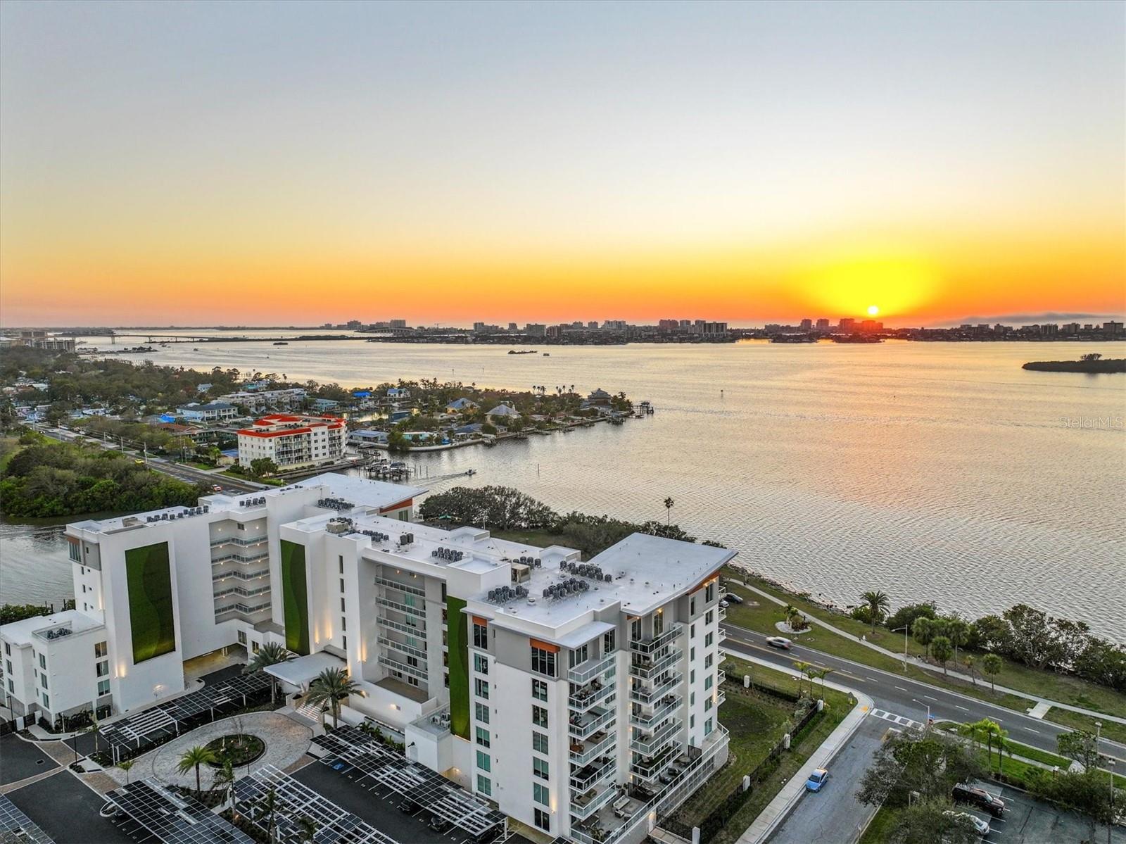 JUST LISTED! An incredible value at the renowned Serena by the Sea! Discover refined luxury coastal living at Serena with approx. 23,000 SF of resort-style amenities and 24-hour concierge. This convenient first-floor residence is elevated above street level and offers 1,420+/- sq ft of interior space, plus an expansive 489+/- SF private terrace, with southern exposure overlooking Stevenson Creek. Enjoy watching the dolphins, manatees, and other marine life play in the water from your open-concept kitchen, appointed with high-end stainless steel Gaggenau appliances, including a 5-burner gas cooktop, French door refrigerator, built-in oven, microwave, and dishwasher. A large waterfall quartz island anchors the space with spacious breakfast bar, paired with custom-made Italian cabinetry and additional lighting upgrades for functionality and visual appeal. Porcelain marbled tile flooring spans the entire interior living spaces and terrace. Two sliding glass doors open from the bright living room to the private terrace. The owner’s suite features a spacious bedroom with sliding glass door offering direct access to the terrace and south-facing water vistas. Its ensuite bathroom boasts a frameless glass enclosed rainfall shower and floating double vanity. The guest bedroom also features its own sliding glass door to the terrace, and is adjacent to the second full bathroom including a tub with shower. The dedicated laundry room offers hookups for washer & dryer is conveniently located next to the kitchen. Residents have access to the professionally designed resort-style amenities, including a heated saltwater pool overlooking Clearwater Bay, poolside cabanas and summer kitchens with grills, a wellness spa, sauna, fitness center, and social lounge. Serena by the Sea is a one-of-a-kind gated, boutique luxury condominium located in Clearwater, just minutes from the world-famous Clearwater Beach and Downtown Dunedin, convenient to St. Petersburg & Tampa, and approx. 18.5 miles to Tampa International Airport. Come tour this one today!