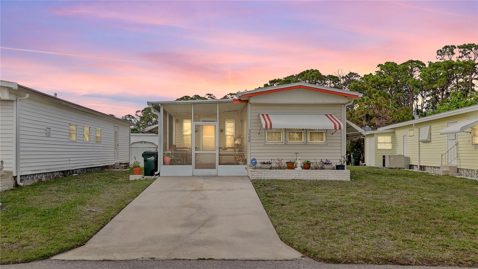 This furnished and fabulously updated Florida retreat is full of charm, comfort, and thoughtful touches throughout. With a bright and airy layout, warm finishes, and a hint of HGTV-inspired style, it’s the perfect blend of cozy and stylish.
Inside, you'll find wood-style flooring, a cheerful kitchen with modern tile backsplash and crisp white cabinetry, and a sunny Florida room surrounded by windows—ideal for morning coffee or hosting a game night. The living spaces are open and inviting, designed for comfort and connection.
The bedrooms are spacious and tranquil, with soft tones and vintage-inspired character. A covered front porch offers the perfect spot to sit and wave to neighbors—and will be freshly painted prior to closing for extra curb appeal. Outside, you’ll find low-maintenance landscaping, a spacious shed for storage and adorable outdoor seating areas for soaking up the Florida sunshine in your screened and covered front porch.
This home is being sold fully furnished and turnkey, minus a few sentimental items, allowing for a seamless and stress-free move-in. Additional features: new A/C in 2023 and new gutters in 2024!
Located in the vibrant 55+ gated community of Holiday Park, residents enjoy a wide range of amenities including two heated pools, clubhouses, pickleball, tennis, shuffleboard, bocce, a fitness center, ceramics building with kiln, darts, ping pong, and more. The community offers an active lifestyle with a full calendar of classes, events, dances, day trips, and group activities.
Whether you’re searching for a seasonal escape or a full-time home, this beautifully updated property delivers comfort, convenience, and community in one delightful package.