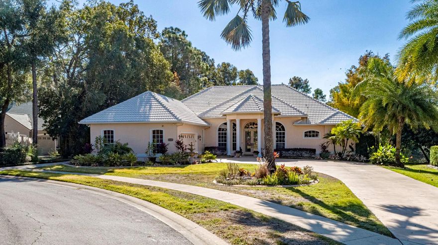 Situated in the highly desired Greenbriar Trail area of the Country Club of Mount Dora, this home stands among the community’s most impressive properties. A palm-lined driveway leads to a stunning tile roof, bubbling fountain, and elegant double front doors adorned with full-length cut-glass panels setting the tone for the quality found throughout the home.  Stepping inside, your gaze is immediately drawn through the formal living room to the infinity-edge pool, which blends seamlessly with the tranquil pond beyond. French doors from the living room open directly onto the pool deck, enhancing the home’s indoor–outdoor flow.  The formal dining room features tall arched windows that bathe the room in natural light —perfect for memorable gatherings.  A beautifully appointed home office offers large windows and generous space. With a closet and a full bath across the hall, this room can also function as a guest suite.  The primary bedroom suite is a true retreat, offering two spacious walk-in closets, new plantation shutters, and French doors that open directly to the pool deck. Its luxurious ensuite bathroom offers a large walk-in shower, soaking tub, and dual vanities.  The home is designed with a split-bedroom plan incorporating two guest bedrooms on the opposite side of the home which share a large full bath. One of the guest rooms features a walk-in closet large enough to accommodate a twin bed! The chef’s kitchen is exceptional in both design and functionality. A central island anchors the space, surrounded by granite countertops and a matching backsplash. The kitchen boasts extra-tall maple cabinetry—so abundant that the owner counted 67 cabinet doors—in addition to a deluxe walk-in pantry. A professional-quality gas range, new refrigerator, Fisher Paykel double-drawer dishwasher, and expansive prep areas make this a cook’s dream. Integrated into the kitchen is an inviting informal dining area with seamless windows overlooking the pool and the pond beyond. The connected family room sits across an informal bar ready for relaxing entertaining.  The space flows seamlessly through pocketed sliding glass doors to the screened pool deck.  The infinity pool appears to merge with the pond below, and the attached Jacuzzi sits perfectly for relaxation. A new Wi-Fi pool heater can warm the spa and pool remotely so it’s ready whenever you are. The pool deck is set up for outdoor dining, has an outdoor kitchen, and includes a comfortable outdoor seating space overlooking 120 feet of waterfront, part of a series of interconnected ponds managed throughout this golfing community.  The extra-large double car garage includes a separate golf-cart area offering outstanding storage and functional convenience.  The home’s infrastructure is equally impressive, providing a central vacuum system, whole-house water filtration and softener, wiring for a small generator.  Living in the Country Club of Mount Dora offers more than just a home—it’s a lifestyle. Optional membership gives access to golf, tennis, pickleball, a large pool, and year-round social events. The charming Mount Dora downtown, just minutes away, is filled with boutique shops, dining, and popular festivals. Plus, with Orlando and its international airport less than an hour away, travel and city conveniences are always within easy reach.  Whether you’re seeking a peaceful retreat or an engaging community to call home, this property delivers!