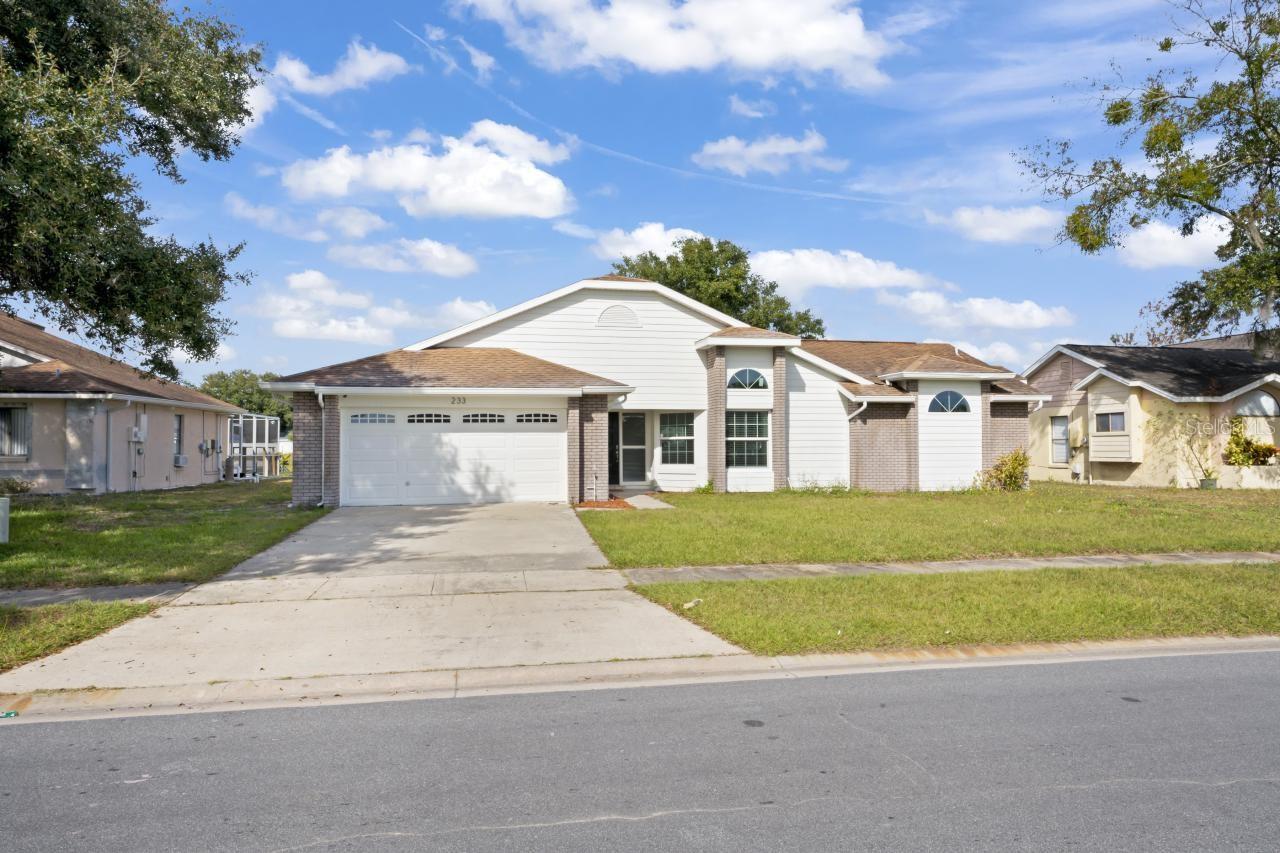 Welcome to 233 Burning Tree Drive, a spacious and beautifully maintained 4-bedroom, 3-bathroom pool home located in the heart of Kissimmee’s desirable Buena Ventura Lakes community. This move-in-ready home boasts a smart split floor plan, perfect for families or guests. The updated kitchen features stainless steel appliances and a breakfast bar overlooking the cozy family room with a fireplace, ideal for relaxing or entertaining. The primary suite is a private retreat with dual closets, double vanity sinks, a garden tub, a separate shower, and sliding doors leading directly to the screened-in pool. Recent upgrades include a newer A/C unit, water heater, water softener, and 11 recently updated windows. The home also features an inside laundry room, a 2-car garage, tile and vinyl flooring, and solid block/stucco construction. Outside, the fenced backyard and screened pool offer a perfect space for Florida living, with a covered front entryway welcoming you home. Conveniently located near Lakefront Park, schools, shopping, major highways, and the future SunRail station, this home combines comfort, space, and location. Don’t miss this opportunity—schedule your private tour today!