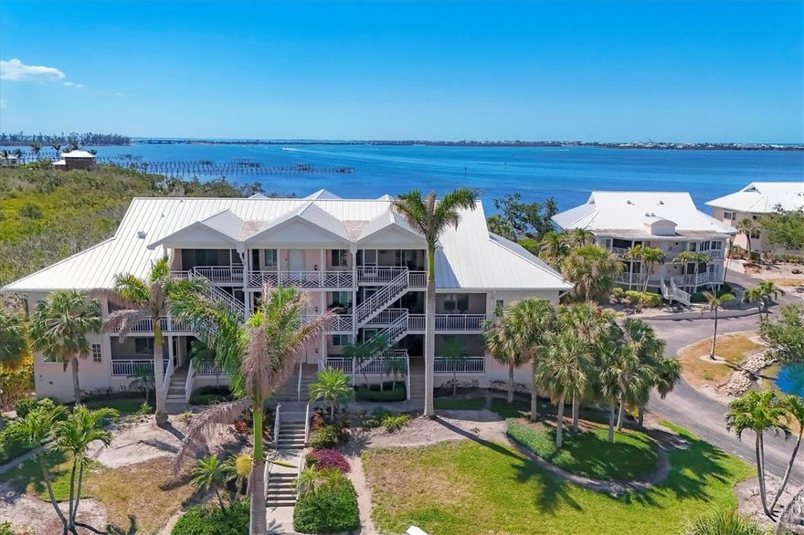 This beautifully renovated 2 bed, 2 bath condo offers stunning views of the bay, Intracoastal Waterway, and Boca Grande causeway. The residence feels private but features both a welcoming front porch and a waterfront lanai, screened and perfect for enjoying sunsets, sea breezes, and Florida's vibrant coastal scenery.  Completely updated in 2021, this condo sustained zero hurricane damage thanks to new impact-resistant windows and doors. Its interior features high-end finishes including a gorgeous kitchen with stone countertops, premium appliances, and custom cabinetry. Both bathrooms are fully remodeled, and new plank tile flooring was installed in the bedrooms and baths. Additional upgrades include crown molding, new HVAC, a new water heater, and deluxe washer/dryer.  Placida Harbour Club is finishing major community-wide enhancements: a completely redesigned harbor facility with new seawall, waterfront walkways for wildlife-viewing and fishing, and 70 boat slips available for lease. It includes a kayak launch and dockage for its new 20-passenger island ferry.  Residents enjoy exclusive access to a private beach, a third heated pool, and clubhouse on Little Gasparilla Island. Its newly constructed pier and ferry landing will include spacious gangways, day-use boat slips, and a fish-cleaning station.  An updated clubhouse, spa, card room and fitness center back on the mainland will open shortly while two resort-style pools and a cabana are ready now.  Placida Harbour Club is close to marinas, golf, dining, shopping, and historic Boca Grande. A coastal retreat with luxury updates, unbeatable amenities, and spectacular water views.