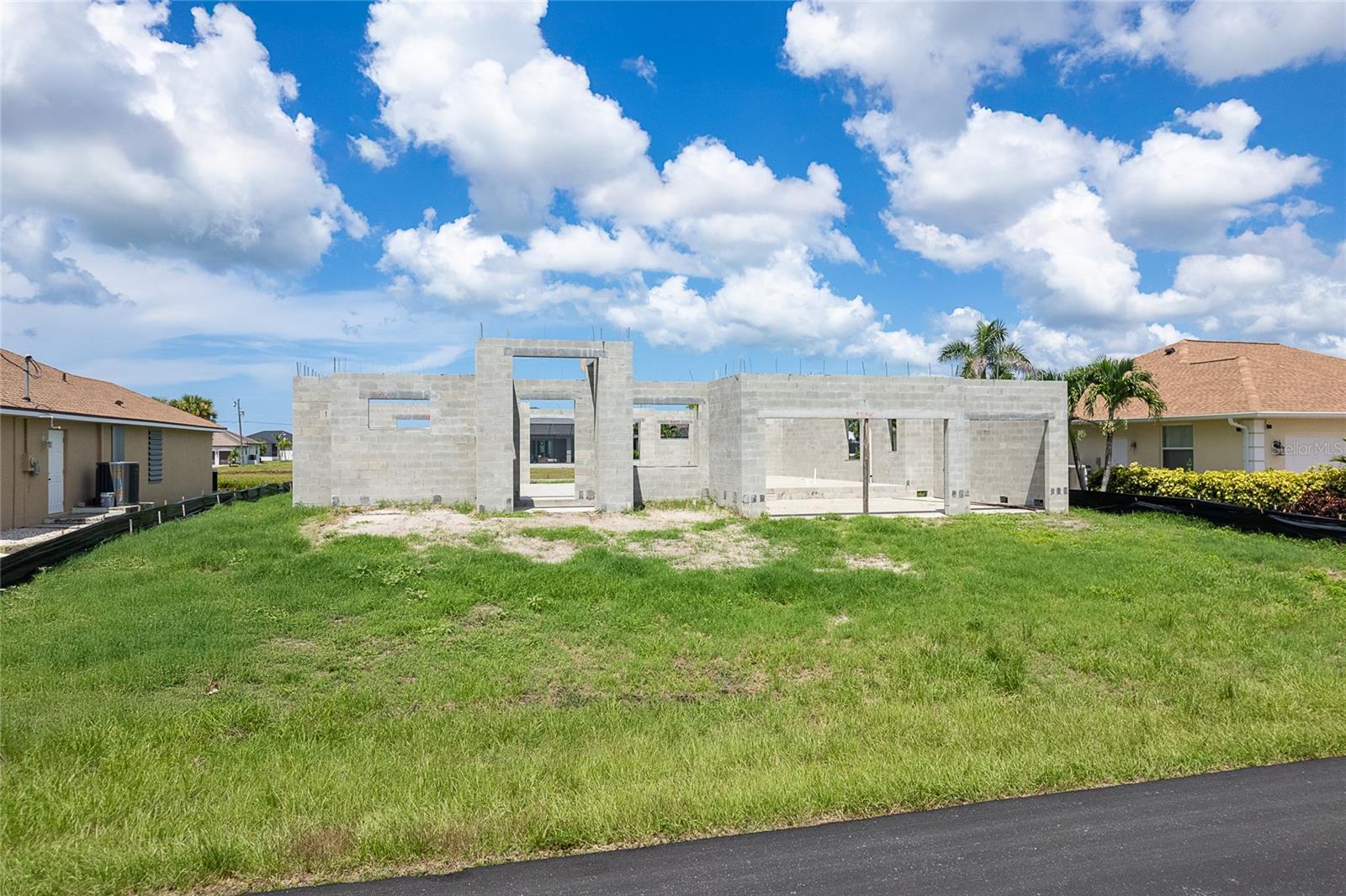 Under-Construction. Great opportunity for investors or home buyers, looking for a new construction home! Customize this home to your personal style and taste and take advantage of current progress for a shorter time to completion. The building permit is in place with approved drawings for this 3 bedroom, 2 and half bath, pool home. Construction began earlier this year (2025), and inspections have passed for the footings, underground plumbing, concrete slab, and bond beam. The soil has been treated, and the home is ready for completion including a stem wall for the pool. Introducing the Catalina 2, an elegant, Coastal-inspired home with room for a private pool and tropical landscaped view of the freshwater canal. The welcoming, open-concept great room, dining and kitchen features ninety-degree pocketing sliders, tray ceilings, and eight-foot doors throughout. The Study provides the flexibility of a home office, craft room, art studio and more! The modern kitchen can be equipped with custom wood cabinetry, quartz counter tops and stainless appliances. Architectural details are emphasized throughout the interior and exterior living spaces of this thoughtfully designed home. The Catalina 2 offers a third car garage, half bath, and a soaking tub in the Owner’s Bath vs. the original Catalina plan. Photos include current construction status as well as a previously completed home for reference only. Call now for details. Do not miss this opportunity!