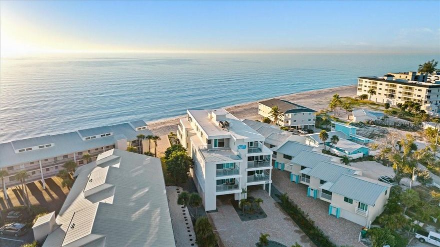 Welcome to The Waves of Manasota Key, a striking modern coastal condominium where contemporary architecture meets effortless luxury. Clean lines, stacked balconies for enhanced privacy, and expansive glass railings maximize natural light and indoor-outdoor living, allowing you to fully embrace the breathtaking views.
This one-of-a-kind building offers the rare luxury of enjoying both sunrise and sunset from your own home. Begin your mornings on the east-facing primary bedroom balcony with serene bay views, and end your evenings watching the sun melt into the Gulf from your west-facing terrace overlooking the private pool and spa that dramatically cantilevers over the pristine waters of Englewood Beach. The glowing oranges and pinks of each sunset feel like a living work of art.
Arrive via private elevator entry and step into an elegant coastal retreat where water views greet you from nearly every room. The open-concept living space is anchored by a beautifully designed gourmet kitchen featuring warm custom wood cabinetry, sleek stone countertops, and a generous center island with bar seating — ideal for entertaining. High-end stainless steel appliances, including a built-in wall oven and professional-grade refrigerator, are complemented by a contemporary glass tile backsplash and thoughtfully designed lighting that enhances both form and function.
The living area flows seamlessly to the west-facing terrace, where your private infinity-edge pool and spa hover above turquoise Gulf waters — making sunset your favorite daily ritual. Steps lead directly down to the beach, where soft sand and gentle waves await just outside your door.
Manasota Key is a charming barrier island offering a relaxed coastal lifestyle with waterfront dining, boutique shopping, and vibrant sunset entertainment. Whether enjoying fine dining or a casual evening by the water, this island community delivers a truly exceptional lifestyle.
This luxurious residence features three spacious bedroom suites, each with a private bath, a guest powder room, over 3,000 square feet of living space, and a private garage. With low-maintenance living and unparalleled design, this is a rare opportunity to own a truly extraordinary coastal condominium.