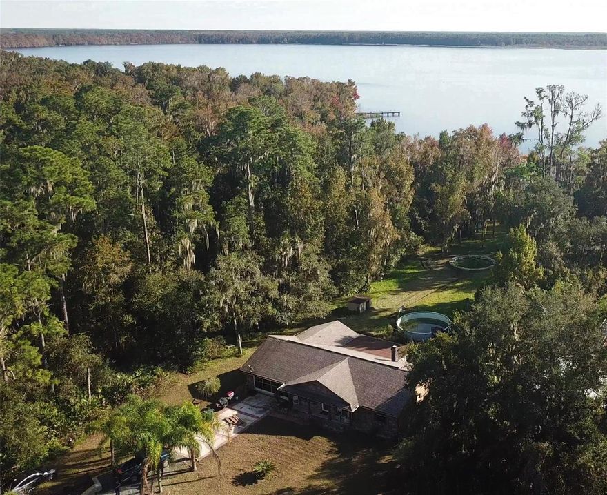 Lake Ashby waterfront 3 bed/ 2 bath block home on 1.96 acres.  Home offers privacy with great views of the lake.  The brick front exterior and paved walkways give good curb appeal as you enter the property.  Inside home is laminate flooring, cathedral ceiling in great room with brick fireplace and open kitchen with stainless appliances and breakfast bar.  The front 2 rooms serve as dining and office space while a nice enclosed porch with tile is directly off the great room on the back of the home.  Outside there are multiple pole barn structures, a paved patio, a large stone firepit, and best of all your own dock.  This property has so much to offer and is conveniently located near several riding preserves, Lake Ashby Park and boardwalk, and only minutes to the beach.  Home is priced to sell quickly.