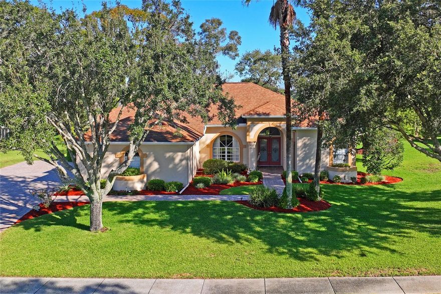 One or more photo(s) has been virtually staged. ONE-OWNER HOME with GOLF COURSE and POND VIEWS!
This beautifully maintained one-owner home near the 5th hole offers 2,468 sq. ft. of comfortable living space with 4 bedrooms, 3 baths, and a 3 car garage.  Built in 1997 and lovingly cared for by the original owners, this home features an open floor plan with high ceilings, a spacious kitchen with granite countertops, and plenty of cabinet space.  Enjoy the large Florida room overlooking the peaceful pond, golf course, and mature trees- perfect for relaxing or entertaining.  The outdoor patio showcases brick, flagstone, and  terrazzo stone, surrounded by freshly mulched landscaping newly painted exterior home for great curb appeal.  Additional highlights include a paver driveway and walkway, Water Heater 2020, roof replaced in 2015,  AC installed in 2008.  This home is located in a quiet, established gated neighborhood close to shopping, dining, and all conveniences. Appliances and extras included: refrigerator, stove, microwave oven, dishwasher, washer, dryer, master bedroom TV, Hot Tub, 2 patio sets with one umbrella, weber grill, 2 ferns and a swing.  Close to the Suncoast Parkway 589 and Tampa Airport. Bike path is right out the back gate.  Come see the well loved home and experience the serene views and inviting lifestyle it offers!