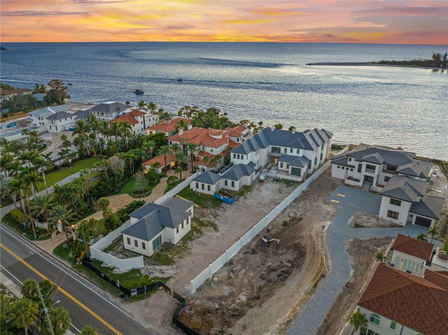 Under Construction. Welcome to 3990 Higel Avenue, set to be completed in early 2026 and can be offered fully furnished. Where architectural brilliance meets unrivaled luxury on Sarasota’s exclusive Gulf-front shores. 3990 Higel is 1 of 1. Having direct ocean frontage while having the ability to have your own private bock/lift. This 13,035 square-foot masterpiece is designed by the acclaimed DSDG Architects,  built by Nutter Construction, and designed by Angela Rodriguez Interiors. This home sits gracefully on one acre of prime Gulf-front property, delivering an unparalleled coastal living experience.

As you arrive, a grand private driveway lined with lush tropical landscaping and a stately entrance sets the tone for this extraordinary estate. The main residence features 5 spacious ensuite bedrooms, meticulously designed with ultra-luxurious finishes, custom millwork, and designer lighting throughout. The interiors blend modern sophistication with timeless elegance, offering soaring ceilings, expansive walls of glass, and seamless transitions between indoor and outdoor spaces.

The great room, bathed in natural light, showcases floor-to-ceiling windows that frame breathtaking views of the turquoise Gulf waters. A reflecting pool with fountain features mirrors the beauty of the estate’s serene surroundings, while retractable glass walls blur the lines between indoor comfort and outdoor splendor. The gourmet kitchen is a culinary dream, outfitted with custom cabinetry, designer hardware, and state-of-the-art appliances, including an oversized island ideal for both entertaining and everyday living.

The primary suite is a sanctuary unto itself, complete with private sitting areas, a balcony with mesmerizing Gulf views, and a spa-inspired ensuite bath adorned with exquisite finishes, soaking tub, and oversized shower. Each additional bedroom offers equally luxurious accommodations, ensuring guests experience unrivaled comfort and style.

Outdoor living rivals a world-class resort with multiple terraces, a sparkling infinity-edge pool, and expansive lounging areas surrounded by lush gardens. A firepit area and thoughtfully designed hardscaping invite al fresco dining and relaxation under the stars. For boating enthusiasts, a private deeded 20,000 lb boat lift provides direct access to the Gulf, seamlessly connecting the estate to Sarasota’s waters.

Adding to the grandeur is a detached 2-bedroom guest house, complete with its own living space, ensuring the utmost privacy and convenience for family and friends. Designed for entertaining, the home also includes a dedicated party room and an elegant wine room to showcase your finest collection.

Every detail has been carefully considered – from the structural integrity and elevation designed for storms to the cutting-edge smart home systems and incredible engineering. This estate represents the pinnacle of craftsmanship and design, set in one of Sarasota’s most coveted waterfront locations.

3990 Higel Avenue is more than just a home; it is a timeless retreat where luxury, tranquility, and Gulf-front beauty converge to create an extraordinary living experience.