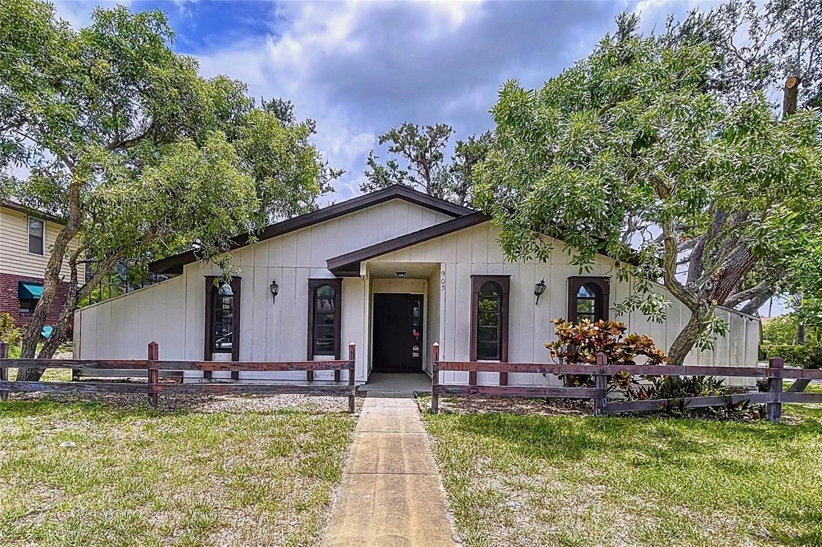 NW Bradenton Home situated on a large 12,062 squ ft lot with beautiful mature oak trees. This 3-bedroom, 2-bathroom home is ideally located near excellent schools, making it perfect for families. It also offers convenient access to fantastic outdoor venues such as Robinson Preserve and Desoto Monument, and is just a short drive from the beautiful beaches of Anna Maria Island. You'll also appreciate its proximity to various shopping options.
The interior of the home provides a spacious feel, enhanced by vaulted ceilings in the living area. It features 2 large pantries in the kitchen and a separate laundry room, adding to its functionality. There's also an enclosed Florida room, which offers additional living space. The property includes a large two-car garage with colossal storage, a circular driveway with plenty of parking and a unique air-conditioned workshop/storage with outside entry. An added bonus is an irrigation system that is well fed. This home is ready for a new owner to update and personalize it and make it their own, offering a wonderful opportunity to reside in one of the most sought-after locations in Manatee County.