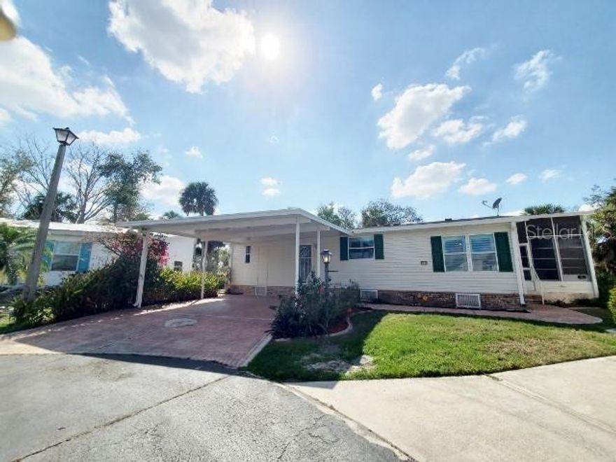 Hidden Dream Found & Located at: 27205 Jones Loop Rd., Lot #31, Punta Gorda, Fl. 33982 in River Side Oaks where You will Love Your Neighbors! This 1998 Palm Harbor Two Bedroom Two Bath has approx. 1232 sq. ft. Plus Side by Side Driveway Plus a side Shed with an attic Plus Lanai Plus a Deck that Extends length of Home in Back which Leads to Your Water View of Alligator Creek & Your Over Sized Mature Landscaped Backyard for Entertaining or Your Fisherman's Secret Spot!  Updates: 2018: New Roof-shingle & Hot Water Heater / 2017: A/C / 2023: Carport / 2024: Gutters. Three Entry's: Carport/Lanai/Back Deck. Inside Laundry ! Washer & Dryer included in Sale. Guest Bed Room will accommodate Queen Size Grouping. Guest Bath Tub/Shower Combo Tile Flooring. Master Bed Room will accommodate King Size Grouping Honey Oak laminate Flooring. Master Bath Shower Plus Linen Closet Dual Vanities Tile Flooring. Hall Tile Flooring. Living Room Honey Oak Flooring Quarter round trim. Open with Amazing View thru Windows! Dining Area with Lighting. Kitchen Tile Flooring. Appliances: French Door Bottom Freezer with Water & Ice in Door/ Range with Hood Microwave/  Dishwasher & Disposal. Lots of Upper & Under Cabinet Space Plus Additional Pantry! Breakfast Bar Counter just add stools! Exit Living Room Slider to Lanai with All Weather Windows Additional movable A/C that also has Heat! Flooring Tile. Lanai exits to Your Deck with New Handrails Two exits to Big Back Yard where All of the Fish come to Splash & Play! Or the Grill Master Cooks for Family & Friends! Call TODAY for Your Exclusive Showing!