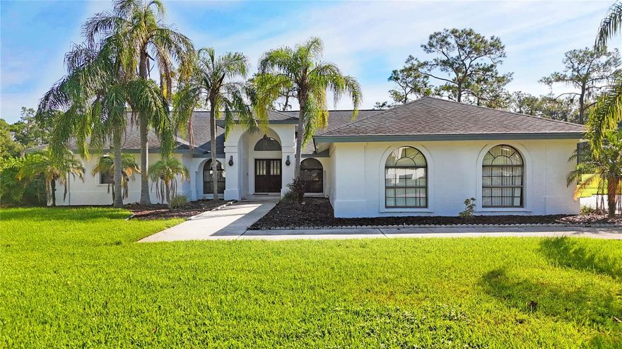 Welcome to refined living! Nestled within the prestigious Hammocks enclave of Walden Lake, this executive 5-bedroom, 3-bath residence spans an impressive 3,084 sq ft and rests on nearly half an acre of meticulously manicured grounds backing up to Mud Lake, offering both grandeur and serenity. Step inside to discover an open-concept split floor plan designed with both elegance and functionality in mind. To the right, the kitchen is appointed with gleaming granite counter tops and a sunlit eat-in breakfast area, seamlessly flowing into the warm and inviting family room where a wood-burning fireplace and wooden beam trim creates a timeless focal point for gatherings. Entertain in style within the palatial formal living room, anchored by an expansive three-panel sliding glass door that beckons you outdoors to the recently upgraded oversized screened lanai. Here, a stately paver deck frames the sparkling pool, creating a true resort-style setting for relaxation and alfresco entertaining. The primary suite is a retreat unto itself—colossal in scale and enhanced by an adjoining flex room accessed through French doors, ideal as a private sitting area or executive home office. The spa-inspired en-suite bath features refined upgraded counter tops, a spacious walk-in closet, and a thoughtful layout designed to indulge. Additional highlights include an indoor laundry room, multiple bedrooms with generous proportions, and the privacy afforded by a nearly half-acre lot—a rarity that elevates this property above the ordinary. The Walden Lake community is perfectly family friendly and  offers amenities such as nature trails and access to community boat ramp for the perfect Florida lifestyle.  The property is perfectly proximal to Plant City shopping and dining, close to West Coast beaches, and 45 min to Disney. Come and see this one be fore it’s gone.