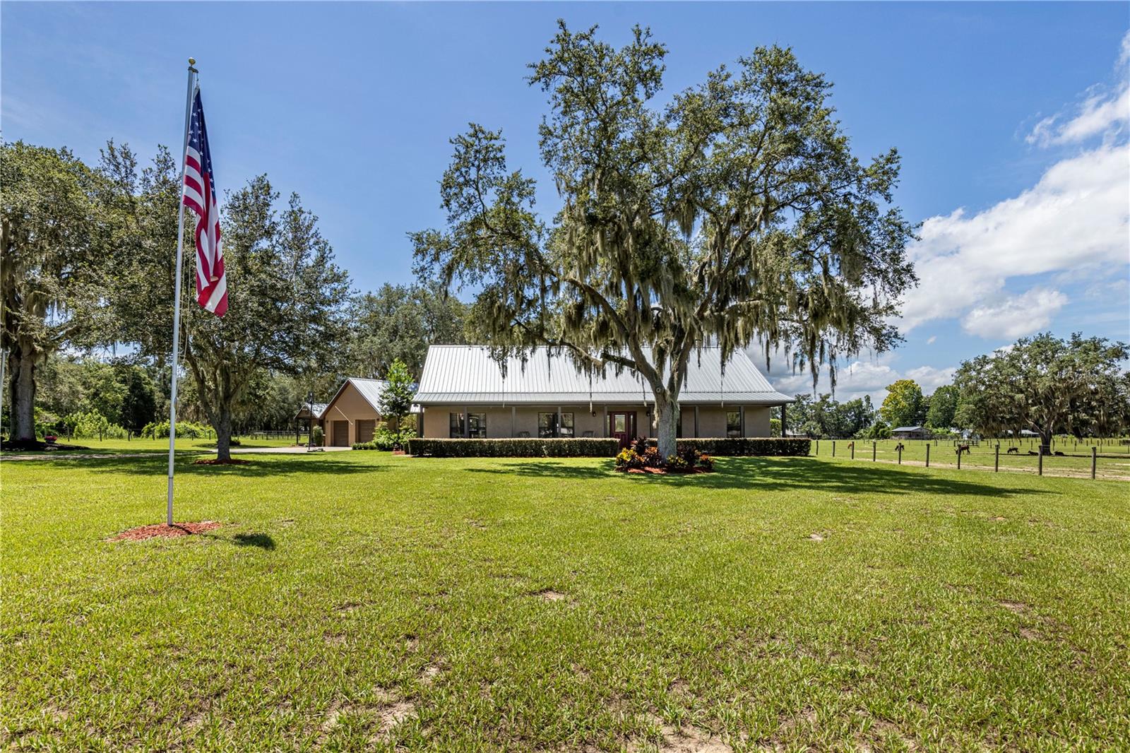 Welcome home! Your search for the perfect homestead is over, as this property offers country living at its finest. This beautiful home has been cherished by the same owner for over 18 years, and now it's ready for a new family to enjoy. Situated on over 3.17 acres, this home features four bedrooms, two bathrooms, and a detached 2-car garage with a separate "she shed." Recent updates include a new metal roof in 2023 on the house, detached garage, "she shed", and even the doghouse, along with a new HVAC system in 2020 and a new water softener system in 2023. The property is high/dry & currently zoned for agriculture, mostly cleared, and cross-fenced, making it ideal for cattle, horses, or goats. The chicken coop is also included! The home has been updated over the past few years with new exterior paint (on the house, detached garage, "she" shed and the doghouse), new interior paint(including doors), new luxury vinyl floors throughout the living room and all four bedrooms, and updated light fixtures and fans. The open floor plan, complemented by huge front and back porches, is perfect for entertaining. The kitchen boasts newer stainless steel appliances (installed December 2023), ample storage with plenty of cabinetry, and generous countertop space for food prep and serving. The living room is spacious with vaulted ceilings, offering a bright and airy feel with abundant natural light. The primary bedroom features a tray ceiling with underlighting, a ceiling fan, luxury vinyl flooring, and an en-suite bathroom. The primary bathroom includes tile floors, dual sinks, a walk-in tiled shower with dual shower heads, and a private water closet. The three additional bedrooms all have luxury vinyl flooring, built-in closets, and ceiling fans. The detached garage is 25x30, easily fitting two vehicles while still providing plenty of room for tools and toys. It also offers additional walk-around attic space for storage. The 24x16 "she shed" includes a wall AC unit and can be used as an office, workout room, craft room, or additional storage space—the possibilities are endless! If you're seeking peaceful, quiet living with space for a few cows and chickens, yet still close to all amenities, call today for your private tour. Homes like this are truly rare! All information recorded in the MLS is intended to be accurate however, it should be independently verified by buyer and their agent. Make sure to watch the Virtual Tour Video!