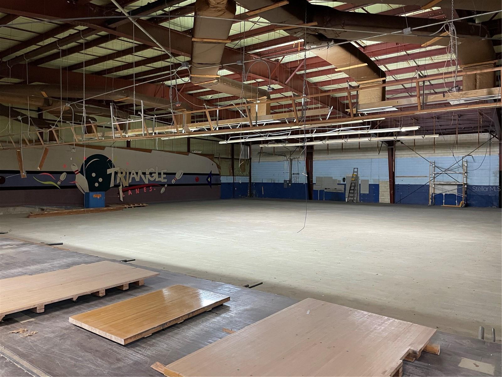 Located at 1530 Eudora Road in Mount Dora, Florida, this premier commercial property is available for sale or lease and offers a unique opportunity for owner-users or tenants seeking high-visibility space in a growing market. The red iron structure spans approximately 14,962 square feet on a 1.72-acre lot and includes roughly 90 paved parking spaces, making it ideal for businesses with high customer or employee traffic. Formerly operated as a bowling alley (Triangle Bowling Alley) and now just a shell free of all bowling equipment, the building features a clear span layout with existing improvements such as a grease trap, hood system, and three 12 1/2 ton AC units, providing flexibility for a variety of adaptive uses or multiple uses. Zoned under Lake County jurisdiction and fully serviced by City of Mount Dora utilities, the property is strategically situated just south of US-441, offering easy access to Tavares, downtown Mount Dora, and the surrounding region. The structure and location are well-suited for a wide range of uses, including self storage, retail showrooms, fitness or recreation facilities, medical offices, hardware or thrift stores, or food service concepts. For lease, the property is offered as a triple-net (NNN) structure, with terms available upon request. This highly flexible space combines expansive parking, municipal utility services, and strategic frontage—delivering an ideal canvas for commercial development or occupancy in one of Lake County’s most desirable corridors. Included photos depict a mock up rendition of what the building could be with modernization improvements.