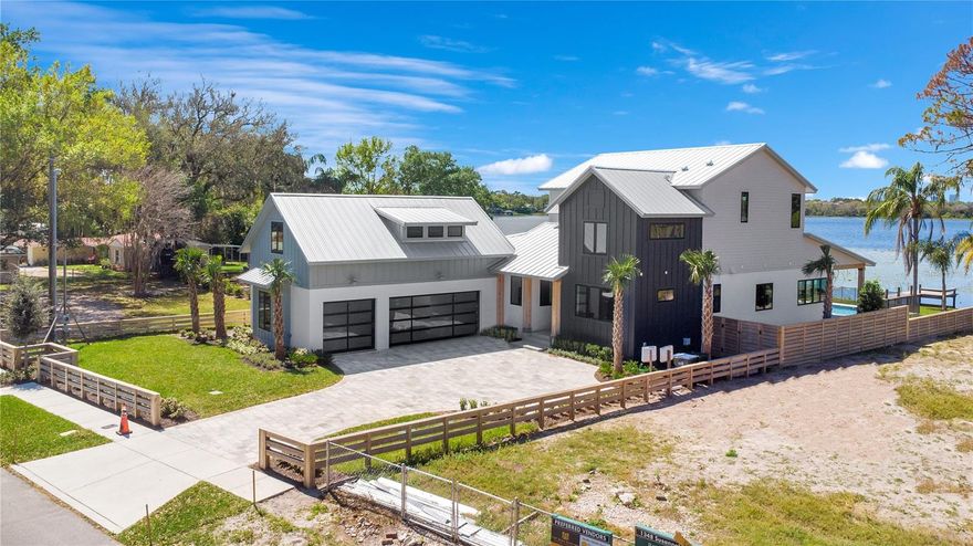 Accepting back up offers, request a showing! Lakefront Luxury on Private, Skiable Lake Susannah!

Experience the pinnacle of waterfront living in this exceptional, custom-designed estate on the shores of Lake Susannah—a private, spring-fed, 78-acre skiable lake known for its pristine waters and peaceful charm. Perfectly positioned to capture sweeping views of the downtown Orlando skyline, this one-of-a-kind residence offers unforgettable Florida sunsets from the comfort of your own resort-style retreat.

The 42-foot pool and spa stretch along the lakefront, designed with sunset-facing bench seating that transforms every evening into a cinematic lakeside experience. Surrounded by lush tropical landscaping, elegant Queen palm trees, and a beachside firepit, the backyard is a true sanctuary—complete with a private dock, ready and waiting for your ski boat. With three distinct outdoor living areas, this home invites effortless entertaining and everyday relaxation all year long.

Inside, no detail has been overlooked. A striking modern staircase serves as the architectural centerpiece of the main living space, where six fully collapsible doors seamlessly connect the indoors to the outdoors, flooding the home with natural light and offering an uninterrupted flow to the expansive lakefront terrace. A dry bar and glass-enclosed wine room add sophistication and functionality, perfect for elevated entertaining.

The primary suite and an additional first-floor guest suite offering convenience and privacy, while the primary dressing room is beyond compare—expansive, elegant, and virtually endless in storage capacity. The gourmet kitchen is both stunning and functional, featuring a hidden walk-in pantry, designer vent hood, built-in refrigerator, and an abundance of custom cabinetry that delivers exceptional form and function. Each additional bedroom offers generous proportions and its own luxurious ensuite bathroom.

The striking three-car garage boasts luxurious designer doors that gleam on the exterior. Upon opening these doors, you are welcomed by extraordinary custom metallic-finished floors! Above, there's a detached bonus suite, perfect for a private gym, art studio, in-law suite, or executive office.

Set just a short stroll from the vibrant Baldwin Park Village Center, and mere steps from the scenic Cady Way Trail, this home delivers unmatched access to the best of Downtown Orlando and Winter Park, while offering the privacy, exclusivity, and serenity of a lakefront sanctuary.

This is more than a New home—it’s a statement and lifestyle. A rare blend of architectural excellence, modern luxury, and refined lakefront living. Welcome to your forever view on Lake Susannah. More pictures to come, call your Realtor for a schedule showing today!