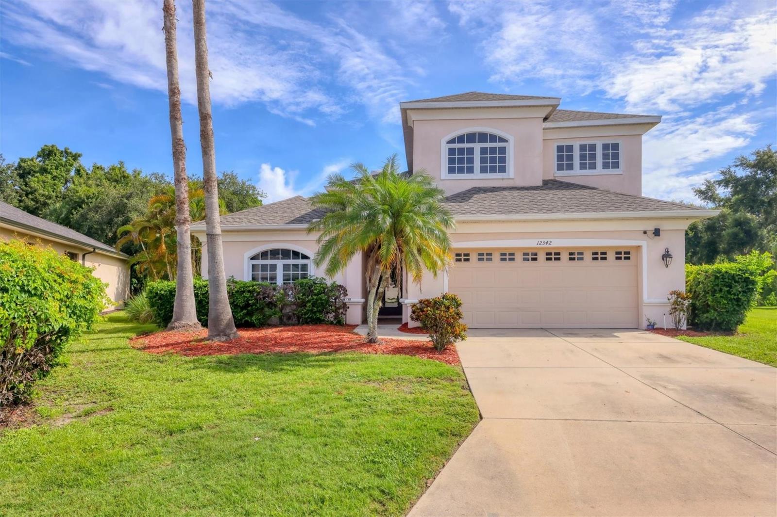 PRICE IMPROVEMENT!! This elegant two-story executive-style pool home offers 2,821 square feet of thoughtfully designed living space, featuring five bedrooms and three full bathrooms. The primary suite and a second bedroom are conveniently located on the first floor, providing flexibility and comfort. Enjoy tranquil views of the private preserve from the spacious living room, which also boasts a cozy fireplace. The open-concept kitchen seamlessly connects to the family room, ideal for both entertaining and everyday living. A large laundry room adds practicality, while the home is nestled within a gated community offering resort-style amenities including a luxurious pool. Abundant wildlife, including frequent sightings of deer, enhances the serene natural setting.