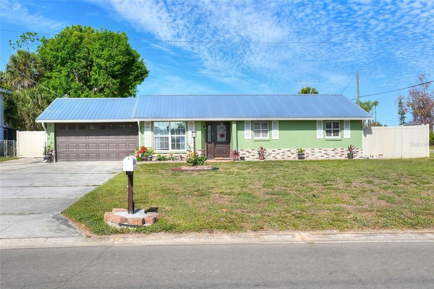 Get this one before she gets away!  NO HOA or CDD, large corner lot with a securely fenced back yard, this 3/2/2 boasts updates galore!  Upon arrival, you will not eat metal roof (2024) and freshly adorned exterior with an expansive driveway with adequate parking for all your guests!  Enter through the brand new front door and experience rooms flooded with natural light, floors easy to maintain, and a floor plan that functions for your every day living needs.  The kitchen is recently updated with granite countertops, stainless appliances, and a large island with eating/working space.  The dining room is currently being used as a classroom, but is spacious for multiple uses.  There's an accessory room/bonus/4th bedroom that is located off the dining area.  Down the hallway the guest bathroom and other bedrooms await.  The primary with en suite provide a spacious retreat.  Venture into the garage dressed with lovely brick paver floors, laundry area, & oversized storage delight.  Backyard besties/hobby chickens are welcome! The secure back yard with lovely vinyl fence enclose ample room for a hobby garden or play space. DON'T DELAY or she might get away!  Make you appointment today!