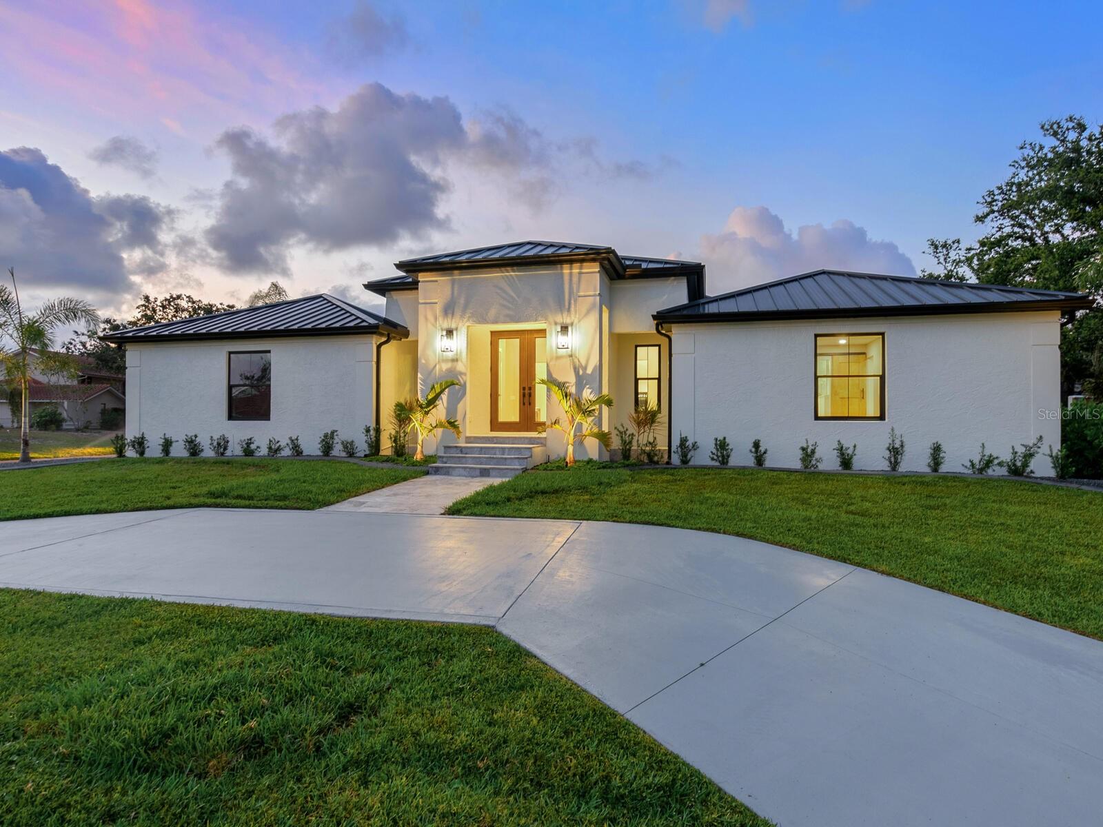 One or more photo(s) has been virtually staged. Welcome to 180 Lookout Point Drive in the sought-after Southbay Yacht & Racquet Club—an extraordinary residence taken fully down to the studs and reimagined as a like-new, luxury smart home. Set on a .4-acre lot in Flood Zone X (no lender-required flood insurance), this five-bedroom, 3.5-bath, 3,236-square-foot home blends solid block construction with high-end design and cutting-edge technology. No detail was overlooked including a standing seam metal roof, all new high-velocity impact windows, hurricane-rated garage doors and fully integrated Alexa features throughout. Wide-plank wood floors lead through a thoughtfully designed layout featuring custom built-ins including a kitchen desk, mudroom storage, dining room bar with wine refrigerator and living room shelving with glass doors. The kitchen is a showstopper with two large quartz islands, top-of-the-line Thermador appliances, a microwave drawer, concealed refrigerator, gas range with double ovens and a custom glass-door butler’s pantry. French doors at the entry feature Alexa-controlled electronic glass for your choice of instant privacy or transparent green views, while oversized sliders in the main living area fully retract for seamless indoor-outdoor living. The massive laundry room is a dream with two washers, two dryers, abundant storage and countertop space. Outside, enjoy a stunning new saltwater pool with cage, paver decking, and a state-of-the-art outdoor kitchen including storage and pullout drawer refrigerators, ideal for entertaining. The oversized garage offers excellent storage and the home’s elevation offers added peace of mind. Southbay is one of Sarasota County’s desirable waterfront communities with an updated clubhouse and fitness center overlooking the bay, complete with a ballroom, catering kitchen, meeting room and library. Community amenities also include a geothermal heated pool, children’s pool, tennis, pickleball, shuffleboard, basketball, kayak storage and a seven-acre deep-water marina accommodating boats up to 55 feet. Residents enjoy 20 acres of lush common grounds and five miles of walking trails, plus a vibrant calendar of social events. Ideally near SR 681 with easy access to downtown Sarasota, Venice, beautiful beaches and A-rated schools including Laurel Nokomis, Sarasota Middle, Venice High, Pine View and the European Academy. This is a rare opportunity to own a turnkey, top-tier home in an unmatched boating community.