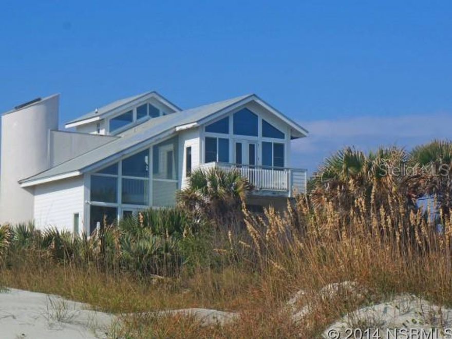 Live at the heart of the beach in this wonderful ocean-front home. Built atop a high dune, the house is situated off 10th Ave in New Smyrna Beach.  If you want casual beach living with open spaces, large rooms, high ceilings, an oversize 2-car garage, views galore and a place for everyone, take a look at this rambler. There are two master suites, plenty of sleeping space for kids and the office can be the 5th bedroom. The renovated kitchen has a Sub-Zero refrigerator, granite counter tops and ocean views. A 38-ft lap pool is protected from the ocean.  This home is located off a charming sand lane with very little traffic and the yard is fenced. ;Water: City