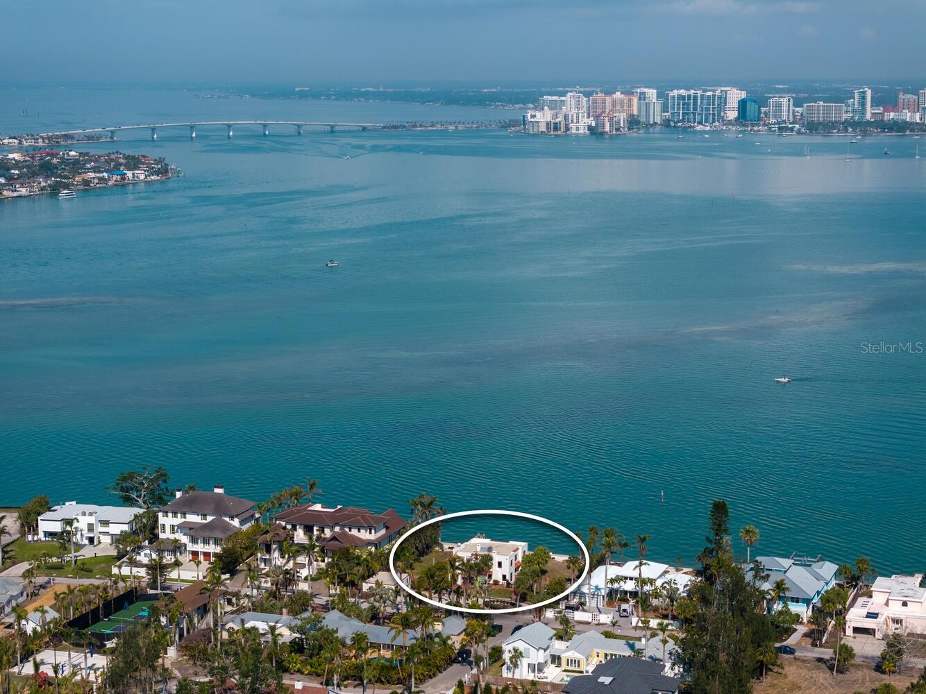 Prime waterfront property located on the prestigious north end of Siesta Key. Nestled along coveted Norsota Way, this exceptional double lot boasts 150 feet of deep-water bay frontage—a rare find in a neighborhood where most properties offer just 100 feet. What truly sets this property apart is its unrivaled, panoramic views of Sarasota Bay and its one-of-a-kind sightline directly onto downtown Sarasota’s dazzling skyline. By day, enjoy an endless expanse of shimmering water; by night, the twinkling city lights create a captivating spectacle. For boating enthusiasts, this deep-water location provides effortless access to the Intracoastal Waterway and Gulf of Mexico, making it a true boater’s paradise. Currently on the lot is a historic, beautifully crafted 3,788-SF Spanish home built in 1926 and featuring three bedrooms and four bathrooms. While it sustained severe damage from the 2024 storms, it can be lovingly restored to preserve its timeless charm or the lot can be cleared to make way for a modern waterfront estate perfectly tailored to your vision. Opportunities like this are exceedingly rare, don’t miss your chance to own a premier piece of Siesta Key’s waterfront, where breathtaking views, deep-water access, and endless possibilities await. The property and structures are being sold as is due to the recent hurricane damage.