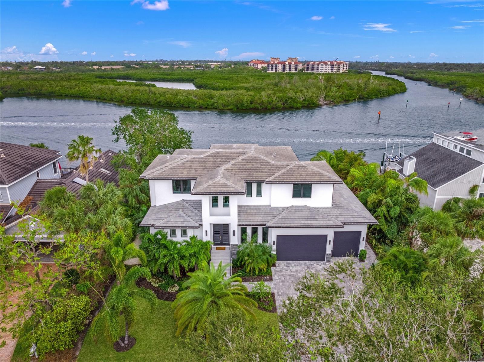 Experience the pinnacle of luxurious waterfront living, where your dreams of boating, entertaining, and relaxation converge in unparalleled splendor. This exquisite elevated custom-built estate on Siesta Key redefines elegance, had NO flood damage, offering sweeping, private vistas of the vibrant intracoastal waterway and showcasing masterful design at every turn.
Spanning two levels of opulent living space, this five-bedroom residence is thoughtfully equipped with an elevator for seamless convenience. Every corner is a testament to refined craftsmanship and attention to detail, featuring wide plank porcelain tile, 8-foot PGT insulated impact doors, a striking electric fireplace, and immersive surround sound that sets the mood for every occasion.
The main level invites effortless entertaining with its expansive living area, complete with a sophisticated wet bar featuring a wine cooler, ice maker, and direct access to the lanai. A spacious den provides a versatile retreat for work or leisure. Upstairs, the family room opens to an oversized balcony, presenting mesmerizing sunrises and panoramic views of the downtown Sarasota skyline.
Culinary enthusiasts will delight in the gourmet kitchen, a chef’s paradise outfitted with state-of-the-art Dacor appliances, double ovens, and sleek quartz waterfall countertops. For alfresco dining, the outdoor kitchen becomes the ultimate stage for creating memorable meals under the stars.
The outdoor living space rivals the finest resorts, with a sparkling pool and spa surrounded by a travertine lanai and deck. Beyond, a newly constructed dock and boat lift await, ensuring your vessel is always ready for adventures on the water.
At day’s end, retreat to the indulgent master suite, a haven of tranquility featuring a spa-like en-suite bath that evokes the ambiance of a five-star resort. Car enthusiasts will appreciate the oversized three-car garage, designed with ample height to accommodate car lifts, perfect for housing your prized collection.
Nestled within one of Siesta Key’s most prestigious communities, this home offers peace of mind with a newly installed generator and the ultimate convenience of proximity to the beach, dining, and shopping—just moments away.
This is not just a home; it’s a lifestyle of unparalleled luxury and elegance, designed for those who desire only the best. Welcome to your paradise.