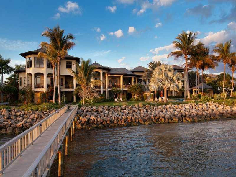 Rarely does a property embody the grandeur to be one of the Gulf Coast's most amazing homes for entertaining and at the same time exemplify a truly comfortable home for everyday life. Experience Villa Solstice, a testament to impeccable design and planning. Set in the historic Museum area on two waterfront lots, this grand estate offers stunning views of the Bay, Ringling Bridge, Longboat Key and the Downtown Sarasota skyline from almost every room. The residence impresses from the moment one enters the grand hallway spanning the length of the home and creating a majestic pathway to all rooms. Brazilian cherry and marble floors, intricate tray ceilings, elaborate panel and crown moldings and expansive custom designed windows and doors throughout are justsome of the highlights that make this home truly one-of-a-kind. Villa Solstice is the perfect venue for entertaining with the large dining room, separate full bar area including 1,400 bottle wine room and access to adjacent music room and to multiple terracing outdoor spaces. In addition to the custom chef's kitchen, the full catering kitchen with elevator, separate staircase to butler's pantry and separate catering garage make large events easy to manage. Complimenting the interior, the outdoor spaces offer some of the best resort style living in all of Florida complete with multiple covered and uncovered patios, a lagoon style zero entry pool, eight person spa, separate pool house with bar and boat dock with multiple lifts.