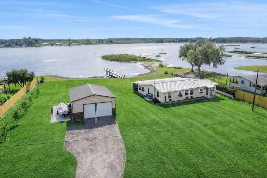 RARE LAKEFRONT RETREAT WITH NO HOA, BRAND NEW DOCK, AND PRIVATE LOCATION
Welcome to this exceptional lakefront residence, tucked away on a quiet dead end street and offering unmatched privacy, tranquility, and breathtaking sunset views over Lake Buffum. This beautifully remodeled 3 bedroom, 2 bathroom home is truly move in ready, having been completely renovated from the subfloor up. Situated on an expansive 1.22 acre lot with approximately 160 feet of pristine lake frontage, the property provides ample space for boating, jet skis, RVs, and all your outdoor recreation. A whole home Generac generator offers peace of mind and uninterrupted comfort year round. Inside, the home features a stunning, fully remodeled kitchen with high end cabinetry, granite countertops, tile backsplash, recessed lighting, modern fixtures, and stainless steel appliances. The open concept living spaces are finished with elegant porcelain wood look tile flooring, while all three bedrooms offer plush carpeting for added comfort. The desirable triple split floor plan provides both privacy and functionality. The spacious primary suite is a true retreat, complete with his and hers walk in closets and a luxurious en suite bath featuring a jetted soaking tub and a large glass enclosed tiled shower. Additional upgrades include double pane windows, a durable metal roof, a spacious indoor laundry room, and a freshly painted exterior. Outdoor living is elevated with a large screened in lanai, perfect for relaxing and enjoying the serene lake views. The newly constructed dock, completed in June 2025, makes lake access effortless and enhances the waterfront lifestyle. The detached 24 x 30 garage and workshop built in 2023 includes power and generous room for storage, hobbies, or recreational equipment. After a day on the water, enjoy the convenience of a fish cleaning station and additional storage located in the pump house and shed. Enjoy privacy with the newly installed privacy fence. 
Whether you are unwinding on the porch, casting a line for bass, or spending the day boating, this home offers lakefront living at its finest. Conveniently located near the new public boat ramp at 2808 Doc Lindsey Road. Homes with this level of privacy, frontage, and upgrades are rarely available. Schedule your private showing today.