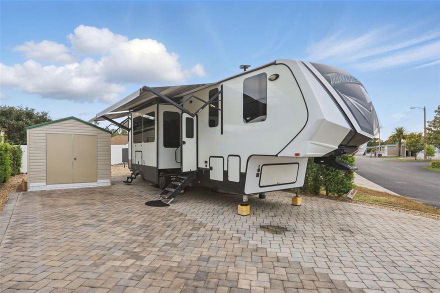 Welcome to your slice of paradise at Elite Resorts at Citrus Valley! This oversized, beautifully maintained lot offers 3,096 sq ft of flexible space with a 2,857 sq ft paver pad, perfect for any size RV or future park model home. The lot includes a 10x10 powered shed with washer/dryer connections, 50-amp electric service, water, sewer, and lush landscaping with hedges and river rock accents. Plus, no rear neighbors for added privacy! Located just 12 miles from Walt Disney World, Elite Resorts offers gated access and outstanding amenities, including two bathhouses, laundry facilities, a clubhouse, a pool, recreation center, and a full calendar of social events like Bingo, entertainment nights, and a Veteran’s Group. The low $756 quarterly condo fee covers water, sewer, trash, cable, internet, grounds maintenance, and on-site management, making this a truly low-maintenance ownership opportunity. Whether you're looking for a winter getaway, a full-time home, or a strong addition to your rental portfolio, this lot delivers. Opportunities like this are rare in Central Florida’s thriving resort market. Schedule your showing today and start living the Elite Resorts lifestyle! **The recreational vehicle pictured is used for visualization purposes only, seller will remove prior to closing date**