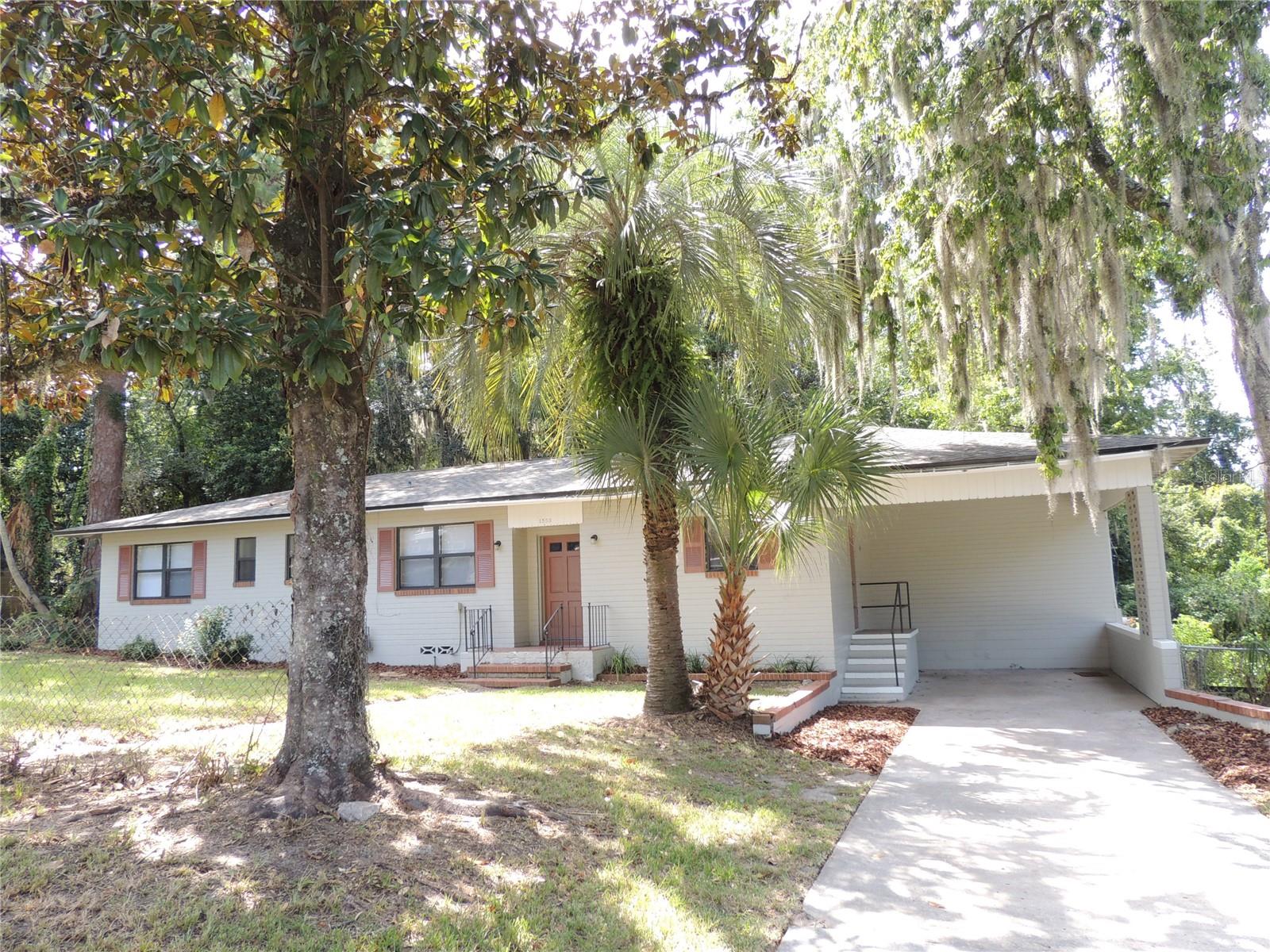 Incredible Opportunity for a solid block 4 bedroom/2 bath home! Step inside this classically styled home and take a step back in time with solid wood flooring thru ought all living areas of the home, large brick wood burning fireplace in living room, separate dining room area, extremely large bedrooms with very spacious closets and storage areas. Both bathrooms feature classic pastel colored tile with a large bathtub in hall bathroom and shower in the owners bathroom. There is ample storage space in the utility room with washer & dryer area. Enjoy peaceful views of the wooded backyard space which is surrounded by chain link fencing. Prime NW Gainesville location in very close proximity to Gainesville High School. Roof replaced in 2022.
