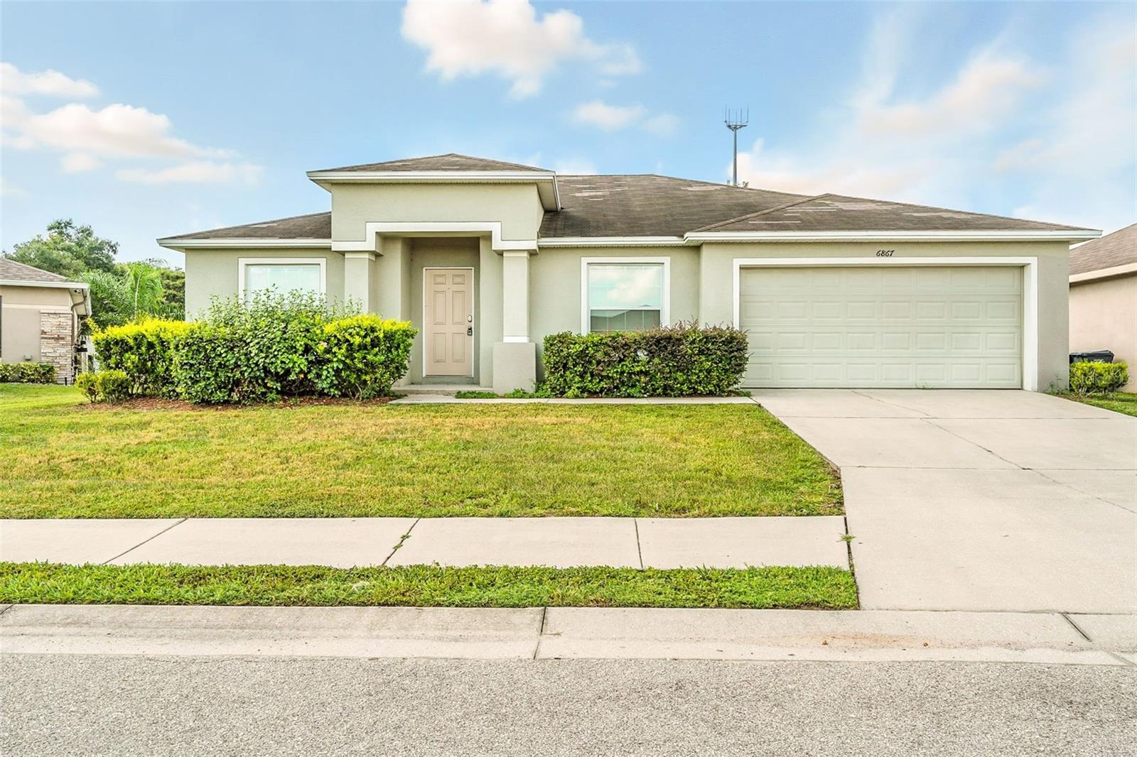 One or more photo(s) has been virtually staged. Spacious and well-maintained 4-bedroom, 2-bath home in the sought-after gated community of Hunters Crossing. This single-level residence offers a split-bedroom floorplan with vaulted ceilings, an open living area, and a formal dining room. The kitchen features granite countertops and a convenient layout that opens to the family space—perfect for everyday living or entertaining. The primary suite includes a walk-in closet and en-suite bath with a garden tub. Additional highlights include tile flooring throughout main areas, carpeted bedrooms, an interior laundry room, a 2-car garage, and a large backyard with irrigation system. Located on a quiet street with easy access to local shopping, schools, and major roadways.