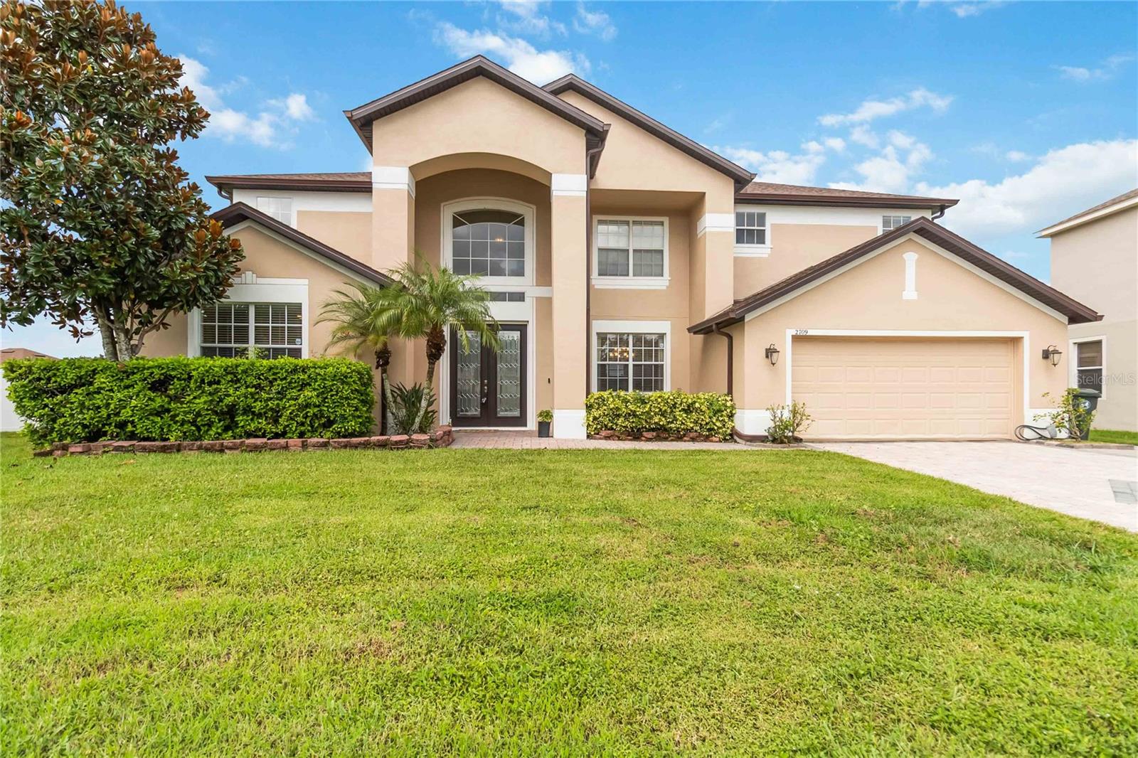 One or more photo(s) has been virtually staged. Are you searching for the perfect family home in a prime location near The Loop shopping center, and close to all theme parks? Look no further! Experience the best of Florida living in this stunning 5-bedroom, 3.5-bathroom pool home with a serene water view. Spanning 3,500 square feet, this residence offers a perfect blend of elegance and comfort. Step into the grand two-story foyer and be captivated by the open-concept living space, featuring beautiful hardwood and tile floors throughout the main area. A high 10-foot ceiling, makes the home feel even more spacious and airy.
The main level is designed for modern living, boasting a dedicated
office , and an eat-in kitchen with warm oak cabinetry, granite countertops, and stainless steel appliances. A large prep island with seating makes it ideal for casual meals and entertainment.
The primary bedroom and ensuite, complete with double vanities, a soaking tub, and a separate tile shower, are conveniently located on the main floor. Upstairs, you'll find plenty of space for everyone. A massive bonus room with laminate flooring provides a versatile area for a media room or playroom. It also includes four generously sized carpeted bedrooms, each with large closets. The bedrooms share two well-appointed bathrooms, ensuring comfort and privacy for family and guests.
French doors lead to a covered patio and a screened lanai overlooking the sparkling pool and peaceful water view. The fully fenced yard, added in 2022, offers ample green space and privacy with no rear neighbors. The paver driveway and walkway add to the home's curb appeal. A 240-volt outlet for an EV- charger is installed in the garage. This home has been meticulously maintained with a new roof in 2024, external paint refreshed 3 years ago, and two HVAC units that are around 5 years old.
Enjoy the convenience of motorized blinds in the family room and on the top windows of the foyer. The property also features a variety of fruiting trees, including guava, mango, papaya, moringa, sapota, pomegranate, and banana.
Located in the gated community of Cypress Reserve, you'll enjoy a low HOA with no CDD fees, along with fantastic amenities including a
community pool, tennis and basketball courts, and a playground. This prime location offers easy access to top-rated schools, dining, and all the attractions Orlando has to offer. Schedule your private tour today to see this exceptional home.