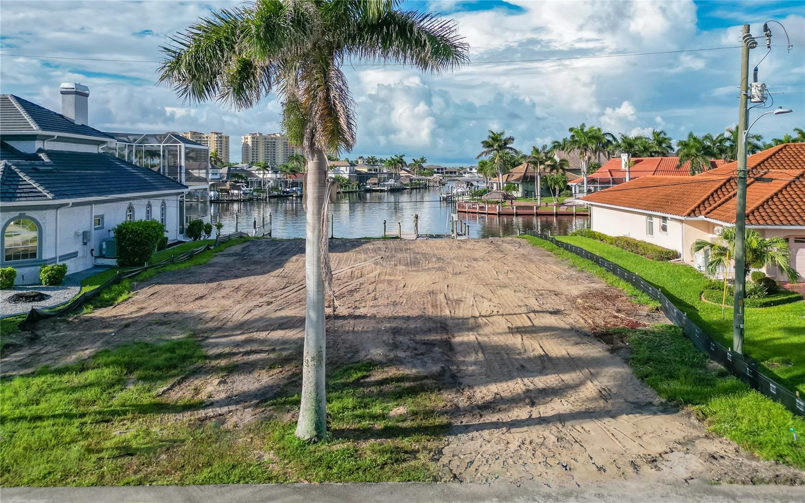 BUILD YOUR NEW CUSTON DREAM HOME ON THIS LUXURY WATER FRONT LOT WITH INTERSECTING CANALS. DIRECT SAIL BOAT ACCESS JUST MINUTES TO THE GULF. LARGE BOAT DOCK WITH A 12,000 POUND LIFT HAS WATER & ELECTRIC HOOK UP. SOUTHERN REAR EXPOSURE. PRISTINE NEIGHBORHOOD WITH ROYAL PALMS THAT LINE THE STREET. FANTASTIC LOCATION - CLOSE TO CAPE HARBOUR. LIVE ENTERTAINMENT, SEVERAL FINE DINING RESTAURANTS, SHOPPING AND SO MUCH MORE. THIS LOT + THIS LOCATION + INTERSECTING CANALS DO NOT COME ON THE MARKET TOO OFTEN.