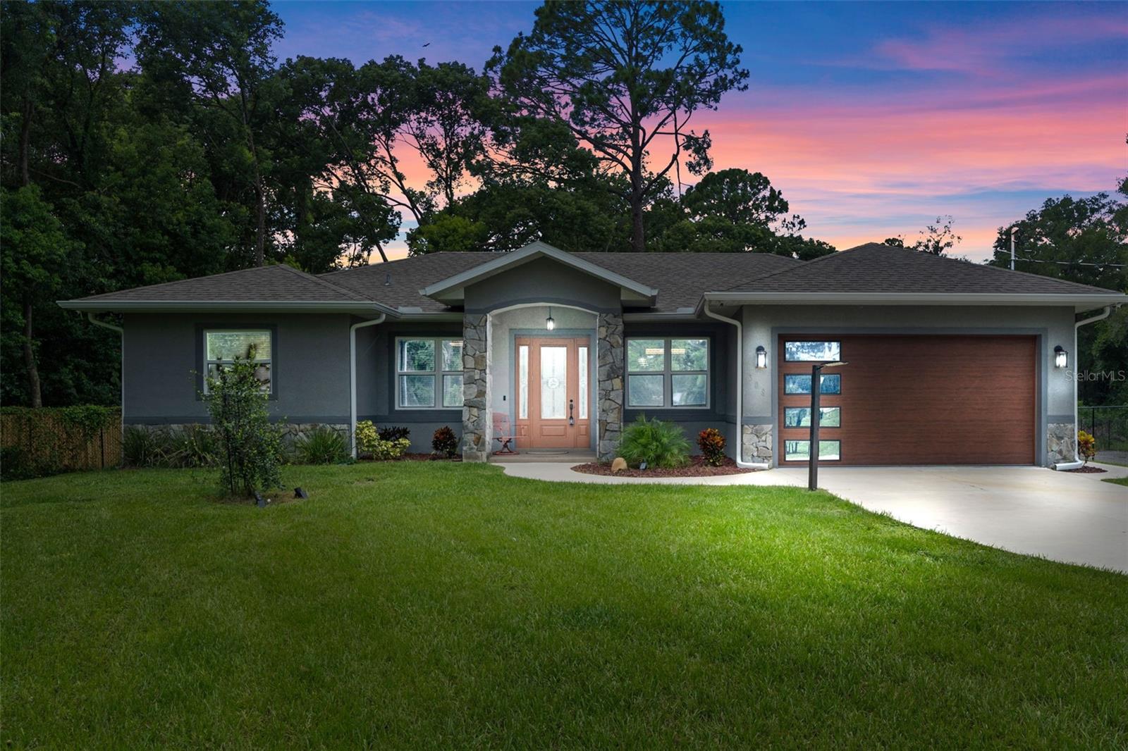 Come admire, fall in love with, and buy a true hidden gem in the quiet, quaint town of Lake Helen with NO HOA. This 4 spacious bedrooms with 2 and 1/2 bath home built in 2021 has many unique characteristics to offer in the detailed craftsmanship within minutes from I-4, only 30 minutes from coast and 45 minutes from downtown Orlando, this home is in the right spot for a piece of mind and serenity lifestyle and just a drive away to the busy and bustle of the city!
The Master suite includes two full walk-in closets, a bathroom with double vanity sinks, garden tub and walk-in shower with a luxurious shower rain head. The open kitchen showcases flagstones tiles, granite countertops, stainless steel appliances, and plenty of cabinet space. This kitchen oversees the natural lit living area built with beautiful marble floors, built-in stone accented fireplace and shelving. Modern lighting, custom window frames, crown molding and high 10ft interior doors throughout really brings this home's charm together! Every detail allows this floorplan to flow nicely. This property sits on just shy of a 2 acre lot, offering privacy, and plenty space for additions or vehicle/boat storage for any of your needs. The rear patio also includes a covered dog kennel and enclosed shed. 08R3 allows this property to be euse for many purposes beyond residential incluiding daycare, group home location, foster care facility (please contact your local Zoning Dept for the full list of options. Security Cameras Night Owl system are included. Furnitures are negotiable. Do not let this gem get away!
