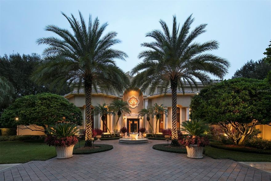 This exquisite estate, built by Pelligrini Homes, sits along the front nine of Isleworth championship golf course and provides breathtaking views of Hole 6. Boasting 6,115 square feet of beautifully curated living space on an oversized lot, this home has been fully restored to the original esthetics from builder designs. Custom ceilings, travertine floors adorned with intricate tile inlays, and carefully crafted shell stone columns are just a few of the distinctive features that elevate this residence. The grandeur of the formal living room is accentuated by its soaring 20-foot ceiling, complemented by a magnificent chandelier and a stately stone fireplace. The heart of the home lies within the chef's kitchen, where custom cabinets, professional-grade Wolf, Thermador, Bosch and Sub-Zero appliances, and granite countertops converge to create a culinary haven. A beautiful groin-vault ceiling adds to the allure while allowing direct access to both the casual dining nook and the formal dining room with a built-in bar for effortless entertaining. The family room, which has an open and airy layout, has a built-in media display and seamless access to the lanai. Retreat to the main-level owner's suite, where a cozy fireplace, dual closets, and a lavish bath await, featuring dual vanities, a walk-in shower, and a luxurious soaking tub enveloped by elegant stone columns. Additional interior highlights include a distinguished home office trimmed with knotty pine wood, a versatile bonus room, and a spacious laundry room outfitted with custom cabinetry. Upstairs, the remaining bedroom suites open onto a sprawling balcony, offering panoramic views of the golf course and the sparkling waters of Lake Bessie. Outside, a haven of relaxation awaits, complete with an open-air swimming pool, a private putting green, and ample deck space surrounded by meticulously maintained landscaping. The European-style lanai, with a graceful balustrade, provides the perfect setting for al fresco gatherings and captivating sunsets against the backdrop of the golf course. This estate epitomizes the ultimate in golf-front living with its unparalleled blend of luxury, convenience, and breathtaking surroundings.