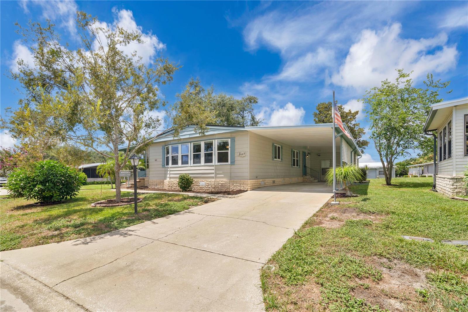Welcome to this beautifully remodeled 2 BEDROOM 2 BATH home, featuring a versatile floorplan with an easy flow. EVERYTHING is NEW within the home! Brand new Roof, HVAC, Water heater, Flooring, Kitchen, Appliances, Windows, Window Blinds, Lighting, AC in the Florida Sun Room, etc..., nothing has been left untouched! As you enter the home you're welcomed into the spacious sunroom which sits just off the large living room and open floor plan, with a large new kitchen island with beautiful cabinets, new stainless steel appliances, and beautiful backsplash. With a dining/flex room and breakfast nook you'll have plenty of options for dining. As you enter the hall way you'll be greeted by the first of the two spacious bedrooms and an inside laundry room with new matching cabinetry as well. The main bathroom has been completed refreshed with all new finishes, including new tile flooring that flows seamlessly with the rest of the home's new flooring. As you enter the over sized primary bedroom, you'll be greeted by the primary ensuite as well with dual vanity sinks and all new fixtures. The outside of the home has a elongated 2 car carport that ties into a storage space, big enough for all of your storage needs. The maturely landscaped corner lot offers a large enough space for even the pickiest of gardeners. ZELLWOOD STATION IS A RESIDENT OWNED 55+ GOLFING COMMUNITY located between Apopka and Mt Dora. It features a 72 par golf course, 4 pools, pickleball and tennis courts; water exercise and line dancing classes, with it's own Whistle Stop Restaurant and Lounge, with banquet facilities. There is always something to do here. Close to the 429 for easy access to airports and attractions, close to shopping, restaurants, medical facilities and churches. Click on the Virtual Tour just under the photos for a full walk through of the home. Don't miss the opportunity to call the amazing property HOME!!!