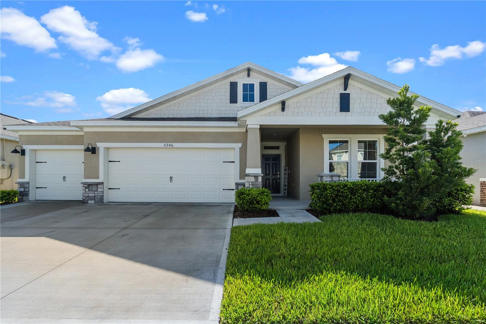 Welcome to 6946 Audubon Osprey Cove – Located in The Villages at Harmony. Discover the perfect blend of comfort, style, and serenity in this meticulously well maintained 4-bedroom, 3 full bathroom home, situated on a premium waterfront lot with no rear neighbors and captivating views of the pond and surrounding conservation area. Enjoy tranquil evenings on your back patio while taking in the sights and sounds of nature, with no rear neighbors and unobstructed views of the water and conservation area. From the moment you step inside, you'll be welcomed by a spacious foyer that opens into an airy open-concept floor plan featuring a large kitchen, spacious dining room, and roomy living room with oversized windows that flood the space with natural light and showcase the peaceful outdoor scenery. The heart of the home is the modern kitchen, complete with granite countertops, a large island with seating for four, and sleek tile flooring that flows seamlessly through all the main living areas. Plush carpet adds warmth and comfort in each of the bedrooms. Retreat to the luxurious primary suite, where you’ll find a spa-like en-suite bathroom featuring a garden tub, separate glass-enclosed shower, and dual vanities with granite countertops. A 3-car garage provides plenty of storage and flexibility for vehicles, hobbies, or a workshop. Washer and Dryer included. Enjoy peace of mind with a 1-year home warranty through American Home Shield covering all your mechanical systems, with full asking price. Located in the highly desirable Villages at Harmony, this home offers the perfect combination of privacy, elegance, and community living. Call to schedule your private showing today and make it your home.