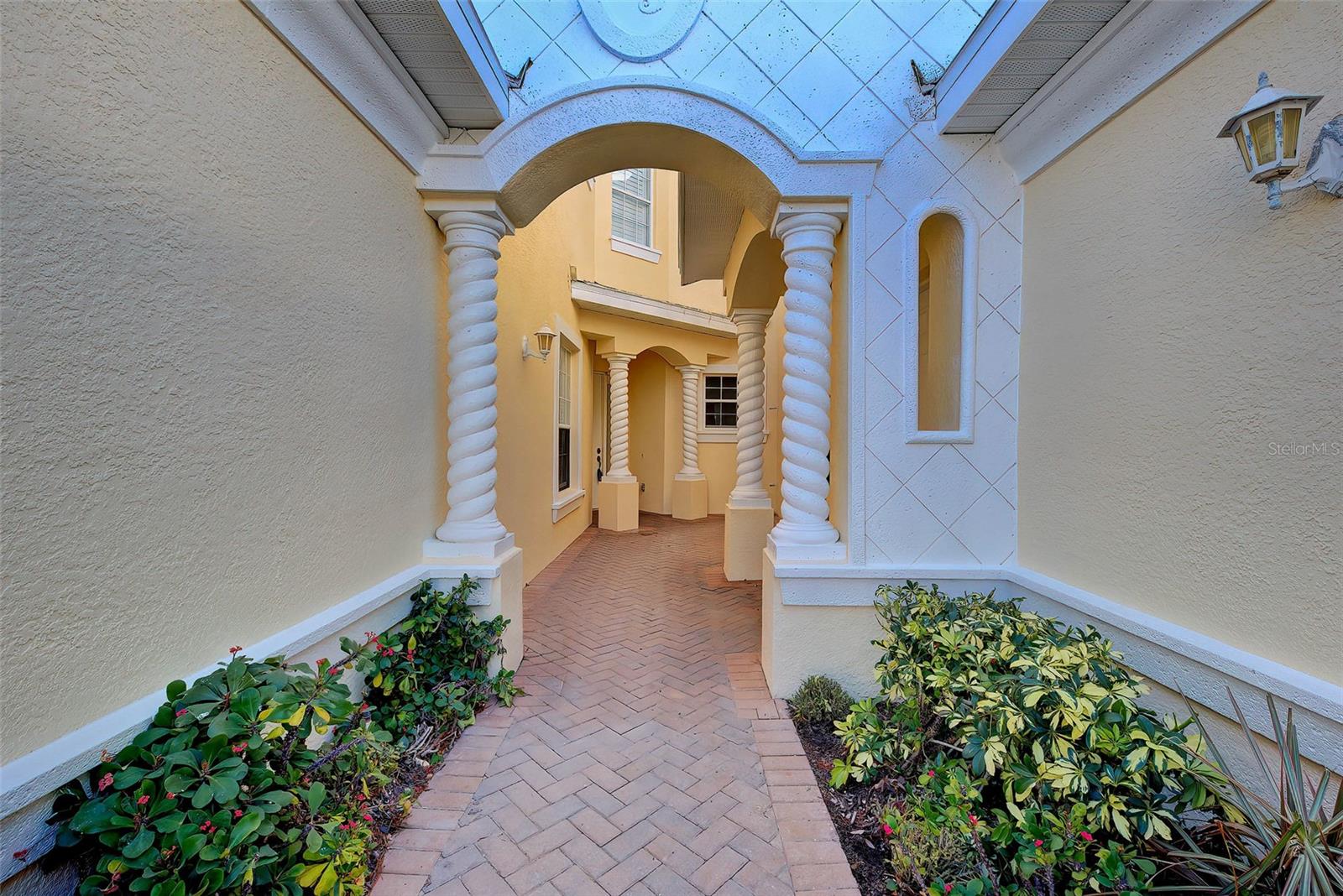 One or more photo(s) has been virtually staged. This condo is a blank canvas—ready for you to create your very own oasis! Enjoy spectacular pond views and watch water birds in action as you entertain from the tranquil lanai, perfectly positioned to capture the picturesque scenery. The spacious, attached two-car garage includes a laundry tub sink and hose bib for added convenience. Located in Triano, a highly sought-after gated community with a resort-like atmosphere, this enclave features just 108 condos across 19 buildings. You'll love the proximity to golf courses, shopping, dining, the Legacy Trail, and the new Sarasota Memorial Hospital. Recent community upgrades include brand-new roofs, gutters, and freshly painted exteriors—all completed at the end of 2024. Stroll through lush garden paths and admire the stunning waterfalls poolside and throughout the grounds. Come explore this peaceful retreat filled with natural beauty and serenity. Experience the best of Florida living!