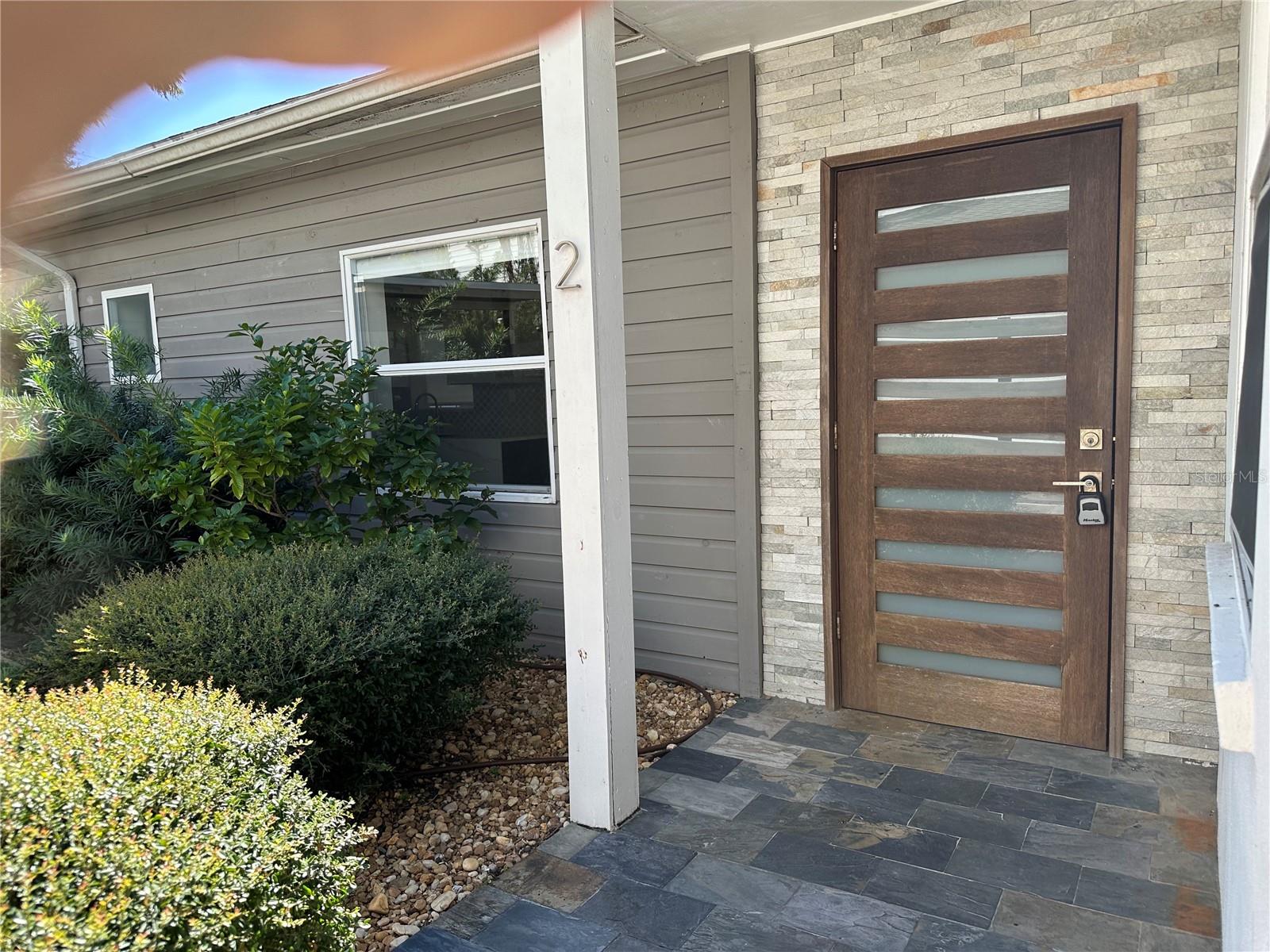 This beautifully renovated mid-century modern home is located in the SoHo/Hyde Park district, walking distance to shops, grocery stores, restaurants, and bars. The spacious home was previously 2 bedrooms (currently being used as 1+den) and 2 full bathrooms, foyer, open kitchen with dining area, separate living area, and a large private deck. The kitchen has modern cabinetry with a breakfast bar, marble counter tops, stainless steel appliances including double gas oven and range, range hood, refrigerator, dishwasher, and pantry with a large dining area, and double French doors leading onto patio. The private patio features a covered area, as well as an open deck, outdoor cabinetry with marble counter top and sink. The master bedroom has an en-suite bath with marble counter top, walk-in shower with glass doors and marble tile, and a large walk-in closet. The guest area is currently being used as a den, and has a walk-in closet and full bath with a tub and marble counter top. Recent upgrades also include new roof, insulation, tankless gas water heater, front loading washer and gas dryer, porcelain tile throughout, and double paned windows. Rent includes water, sewer, garbage, lawn maintenance, and 2 parking spaces.