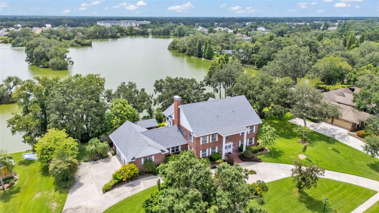 Located in the established community of Christina Woods, this one-owner all-brick two-story home offers timeless architecture, peaceful lake views, and solid value with major updates already in place—including a brand-new roof and AC system installed in 2024.
Set on an expansive lot with a circular driveway and three-car garage, the home makes a strong first impression. Inside, a grand staircase and classic chandelier welcome you into a layout that feels both spacious and thoughtfully designed. The family room stands out with soaring vaulted ceilings, a rich brick wood-burning fireplace, and three-panel double doors that frame beautiful water views and open onto a spacious back patio—ideal for relaxing or entertaining. Just steps away, a brick picnic house with built-in grill and sink adds extra functionality for outdoor gatherings.
The home features four generously sized bedrooms, each with its own private bathroom, plus a cozy home office with built-in shelving. The primary suite offers a bright en suite bath with soaking tub, walk-in shower, and walk-in closet, while two guest bedrooms enjoy private balconies overlooking the backyard and lake.
The kitchen is anchored by real wood cabinetry, stone countertops, and stainless steel appliances, offering a solid, functional space ready for your personal updates. While some finishes may feel dated, this home has been well cared for by its original owner and offers a combination of size, lake access, and location that’s hard to find in today’s market.
Homes like this in Christina Woods don’t come up often. Schedule your showing today and see the potential and peaceful lakeside living for yourself.