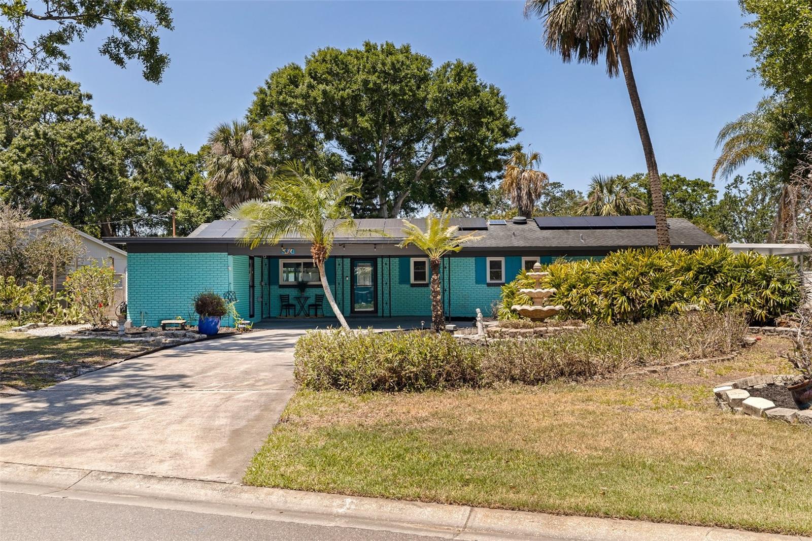 If you’ve been looking for a beautifully renovated pool home with a spacious yard, this is the one! This three-bedroom, two-bath home is in Bay Crest Park, a waterfront community with private boat access to Tampa Bay. On just under a quarter acre, you’ll love the lush landscaping, circular driveway, screened-in porch, covered carport, solar panels and thoughtful modern updates throughout. Enter into an open floor plan with views of the tropical backyard and pool. The home features new luxury vinyl plank flooring and ceramic tile throughout. The kitchen showcases a clean Scandinavian design with a deep apron sink, beautiful gold fixtures, new appliances and quartz countertops. Both baths have been renovated with modern vanities and updated lighting, and the primary bath features a spacious walk-in shower. The primary bedroom is filled with natural light from large sliding glass doors and includes a generous walk-in closet. There are several storage closets throughout the home, along with an oversized indoor laundry room that’s plumbed for a laundry sink. The backyard is your tropical oasis, with a screened-in porch, a sparkling pool with solar heating and freshly serviced equipment, plenty of green space and full fencing for privacy. Additional features include a shed, kayak racks, a covered carport and a circular driveway for added convenience. All windows and doors are hurricane-rated, new pool equipment and HVAC, and the solar panels are fully paid off and included in the sale. Enjoy luxury living in a waterfront community with no HOA or CDD fees. The private community boat ramp and dock are just around the corner, giving you easy access to launch your boat, wave runner or kayak into Tampa Bay. There’s even room in the yard to park your boat or RV. Bay Crest is centrally located, less than five miles to Tampa International Airport, under 10 miles to Hyde Park and with quick access to Pinellas County via the Courtney Campbell Causeway.