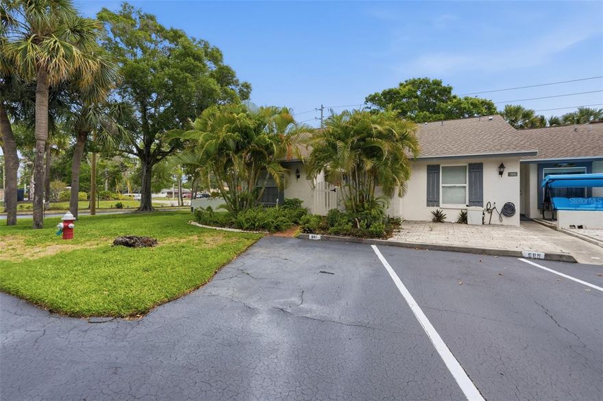 Welcome to this charming 2-bedroom, 2-bathroom end-unit villa in Largo offering over 1,100 square feet of comfortable living space and a desirable split floor plan. A welcoming front patio creates the perfect spot to enjoy your morning coffee or relax in the Florida sunshine. Step inside to discover high vaulted ceilings that enhance the spacious and airy feel of the home. To the left, the kitchen offers abundant cabinet space for storage, a convenient breakfast bar, and a pass-through window overlooking the dining area, making entertaining easy and functional. The open dining room and living room combination creates a bright and inviting atmosphere, while sliding glass doors from the living room lead to a screened-in porch perfect for enjoying the outdoors year-round. The split-bedroom layout provides added privacy, with the primary suite featuring an attached bathroom complete with a glass-enclosed stand-up shower. The second bedroom and full guest bathroom offer comfortable accommodations for family, guests, or a home office setup. Residents can enjoy access to the community pool, conveniently located at the end of the street, and the convenience of an assigned parking space. Ideally located near numerous dining options, shopping centers, parks, and everyday conveniences, this villa is also less than 20 minutes from the beautiful shores of Belleair Beach, making it easy to enjoy the best of Florida coastal living. Schedule your showing today!