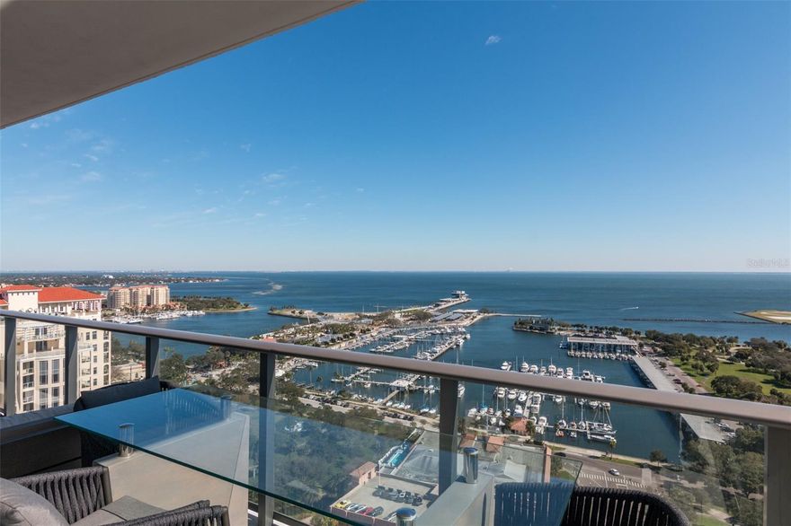 Exquisite Water View Living at ONE St. Petersburg! Experience the pinnacle of luxury living in downtown with this stunning water-view residence at the iconic ONE St. Petersburg tower. Encompassing a spacious 2,475 interior square feet, and THREE private terraces totaling 605 square feet, this meticulously renovated condo by Haven Design redefines elegance and sophistication.

As you step inside, you'll be welcomed into an elegant foyer with eye-catching lighted shelving accented by  the warmth of rich hardwood flooring that flows seamlessly throughout the residence. The expansive great room, including built in credenza/tv and accent wall enhanced by a custom-designed ceiling with LED ambience and recessed lighting, is the perfect space for both intimate gatherings and grand entertaining. Electric blinds, powered by Lutron's quiet technology motors, offer effortless privacy while allowing you to enjoy the breathtaking views of the sparkling waters and twinkling city.

The gourmet kitchen features Artwood Walnut Cuba cabinet doors, a sleek white quartz countertop, and top-of-the-line jennair appliances. The Franke single bowl sink adds a touch of modern elegance to this chef's haven.

Retreat to the serene owner’s suite, where luxury meets tranquility. Two separate walk in closets with built-in cabinets and racks ensure plenty of space to house all your finest clothing and accessories. The ensuite bath is a masterpiece of design with 24” x 24” Nuvo Calacatta Gris Porcelain tile flooring, matching shower walls, and a white quartz countertop. The opaque shower enclosure adds a touch of privacy and sophistication. The guest bathrooms mirror this opulent design, ensuring that every corner of the home exudes luxury.

The residence also includes a den area that opens to the terrace. One of the two guest rooms was custom designed as an office with a stunning built-in desk and gorgeous open shelving making it the perfect home office. Additional features include a built-in buffet and wine rack in the dining room, masterfully selected and professionally hung wallpapers, a whole house water filtration system and a state-of-the-art Toto Neorest toilet.

This residence also includes two assigned parking spaces on the third floor (P3-04 & 05) and climate-controlled storage, ensuring your every need is met with the highest level of convenience.

Residents of ONE St. Petersburg enjoy unparalleled amenities. The 7th-floor social rooms offer a variety of spaces for entertaining, while the 40,000-square-foot private elevated amenities deck provides a resort-style pool, a 5,000-square-foot fitness facility, and intimate cabanas surrounded by lush greenery.

With a walkability score of 92, you are just steps away from the best that downtown St. Petersburg has to offer. Explore the vibrant restaurant scene, boutique shopping, world-class museums, the new St Pete Pier and a variety of cultural events—all within walking distance.