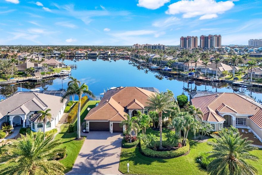 Welcome to your waterfront oasis in the upscale boating community of Cape Harbour. This completely remodeled and reimagined home offers one of the BEST waterviews in the community with an expansive view of Round Table Lake and only minutes to open water! Upon entering through the natural mahogany doors from Borano, you’ll be swept away by the tremendous amount of light in this open concept home. The remodeled gourmet kitchen features hardwood cabinetry and an 11-foot island topped with translucent Cristallo that lights from beneath. The owner’s suite features a custom enlarged dressing area, new Kohler shower and sink fixtures, Dolmite stone countertops, double size custom concrete tub, rain glass windows, marble shower floors, and all new lighting fixtures. The guest side of the home features a unique flex wall along one of the bedrooms allowing for more natural light as well as a large custom concealed wall safe to store valuables. Whole house updates include Unified contemporary plank tile flooring throughout, new light fixtures, and new hurricane grade windows and doors, including a 10 ft tall triple sliding door at the rear of the home, and fresh paint. If you enjoy entertaining you’ll love doing so on your beautiful white shell stone pool deck with outdoor kitchen. The renovated saltwater pool with infinity edge offers an extra large sun shelf and contemporary spa with LED color changing light system. Your outdoor kitchen is equipped with Perlick double door refrigerator, Twin Eagles Grill w/ burner, granite counters and Tiki hut covering the 6 person bar seating. Boaters will appreciate the 2 boat lifts (5k lb and 20k lb) and large dock space with Come-Along for in water boat parking. Dock was rebuilt in 2020 with new electrical wiring and ambient lighting. Other updates include New whole house Generac generator and insulated Garage door with hurricane bracing. Don’t miss your opportunity to live the Florida dream and schedule your private tour today!
